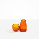 Dinosaur Designs Glass Pebble Carafe in Amber color resin