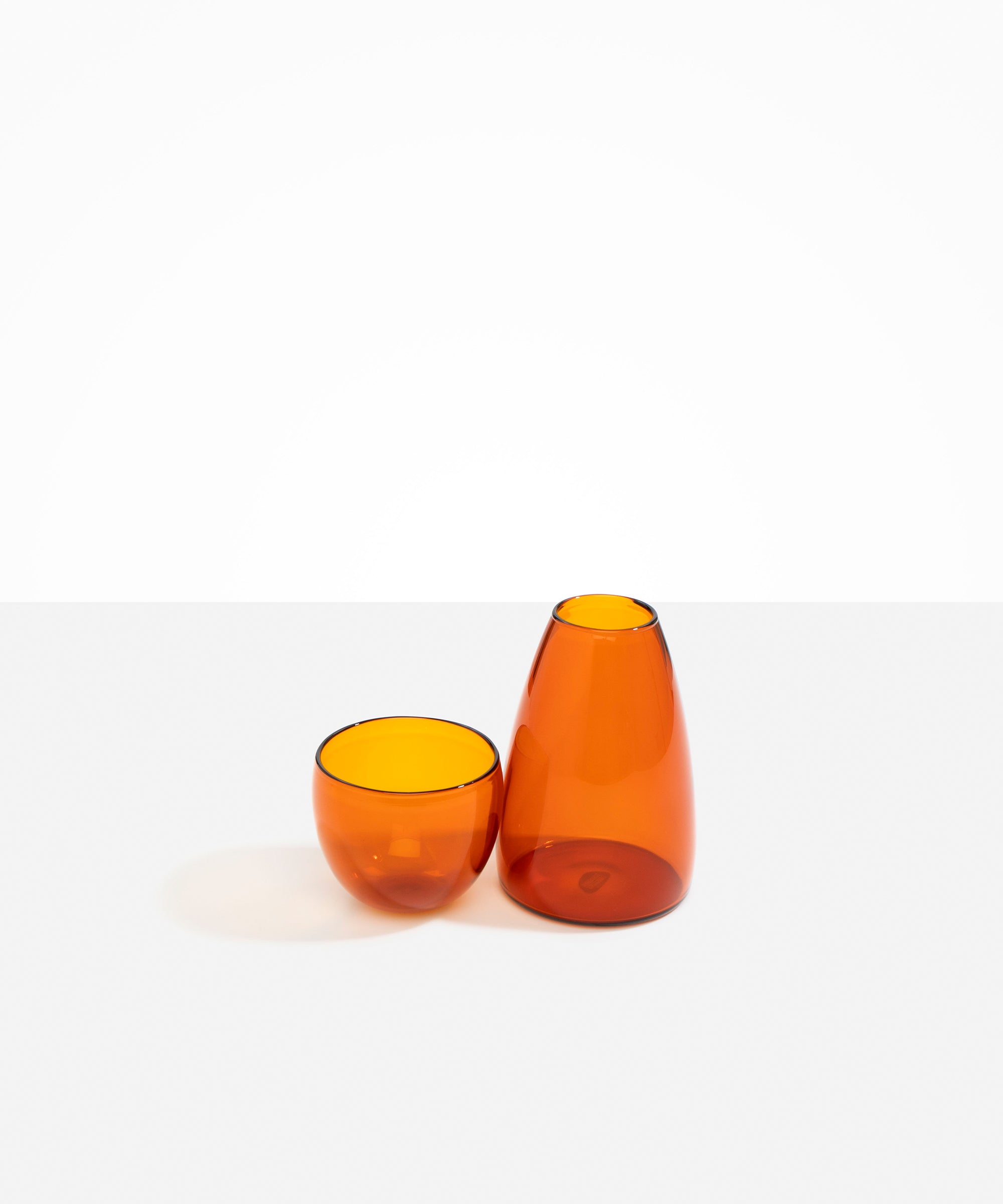 Dinosaur Designs Glass Pebble Carafe in Amber color resin