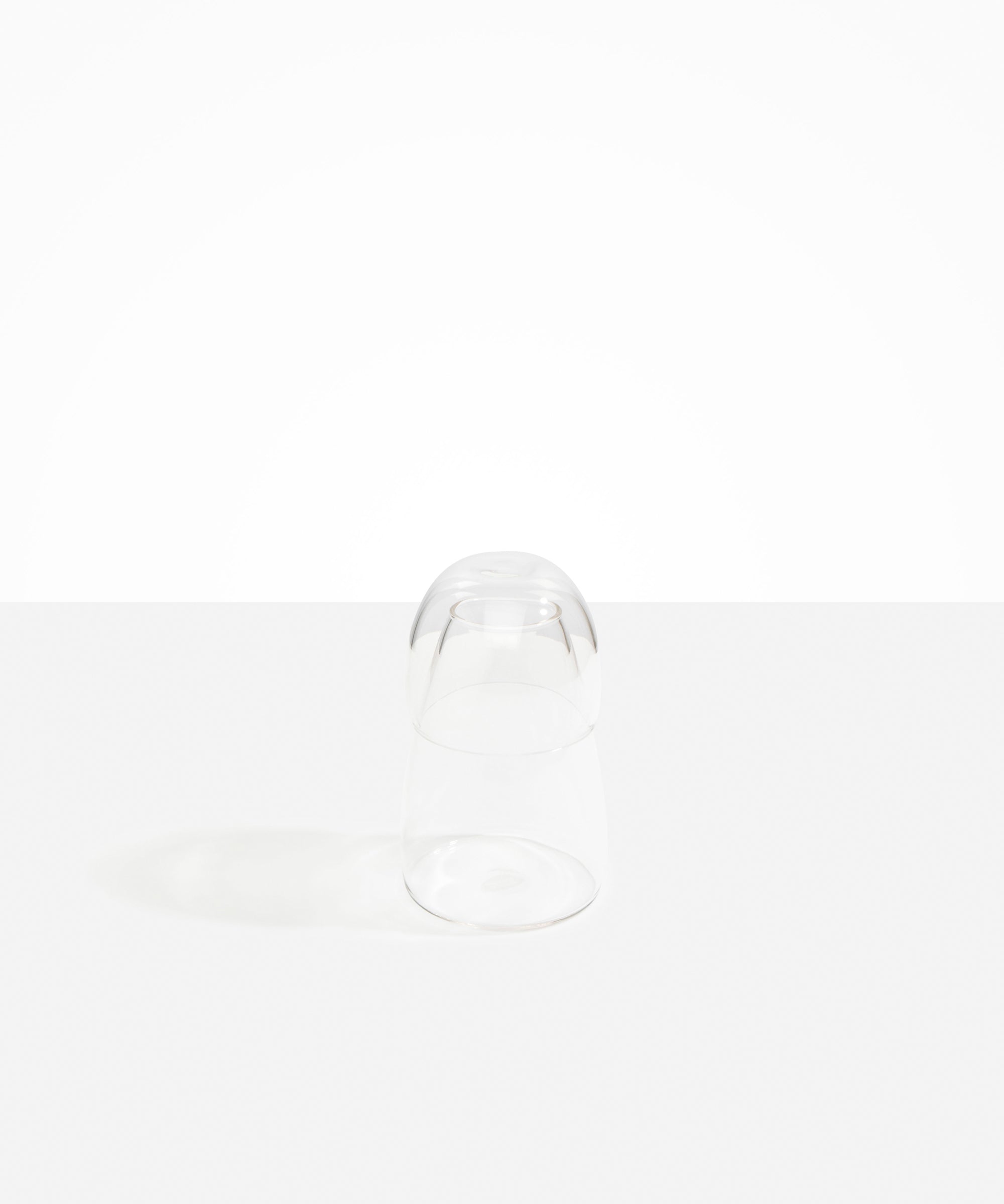 Dinosaur Designs colored Glass Pebble Carafe cup and jug set in transparent clear.