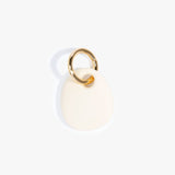 Dinosaur Designs Earth Keyring in Cream color resin with Brass Metal