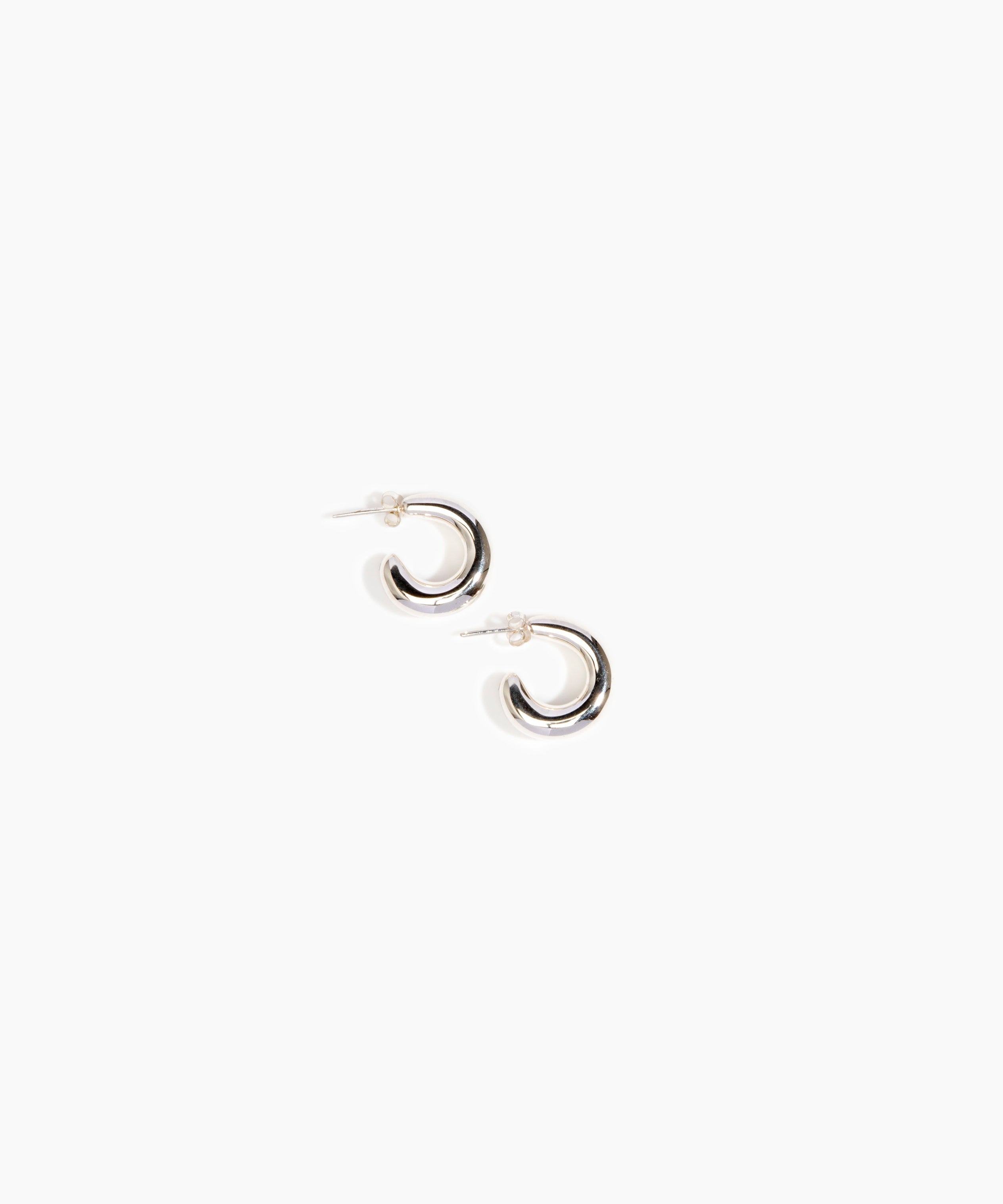 LO Collections Large Liquid Loop Earrings in Silver-Plated Brass Material..