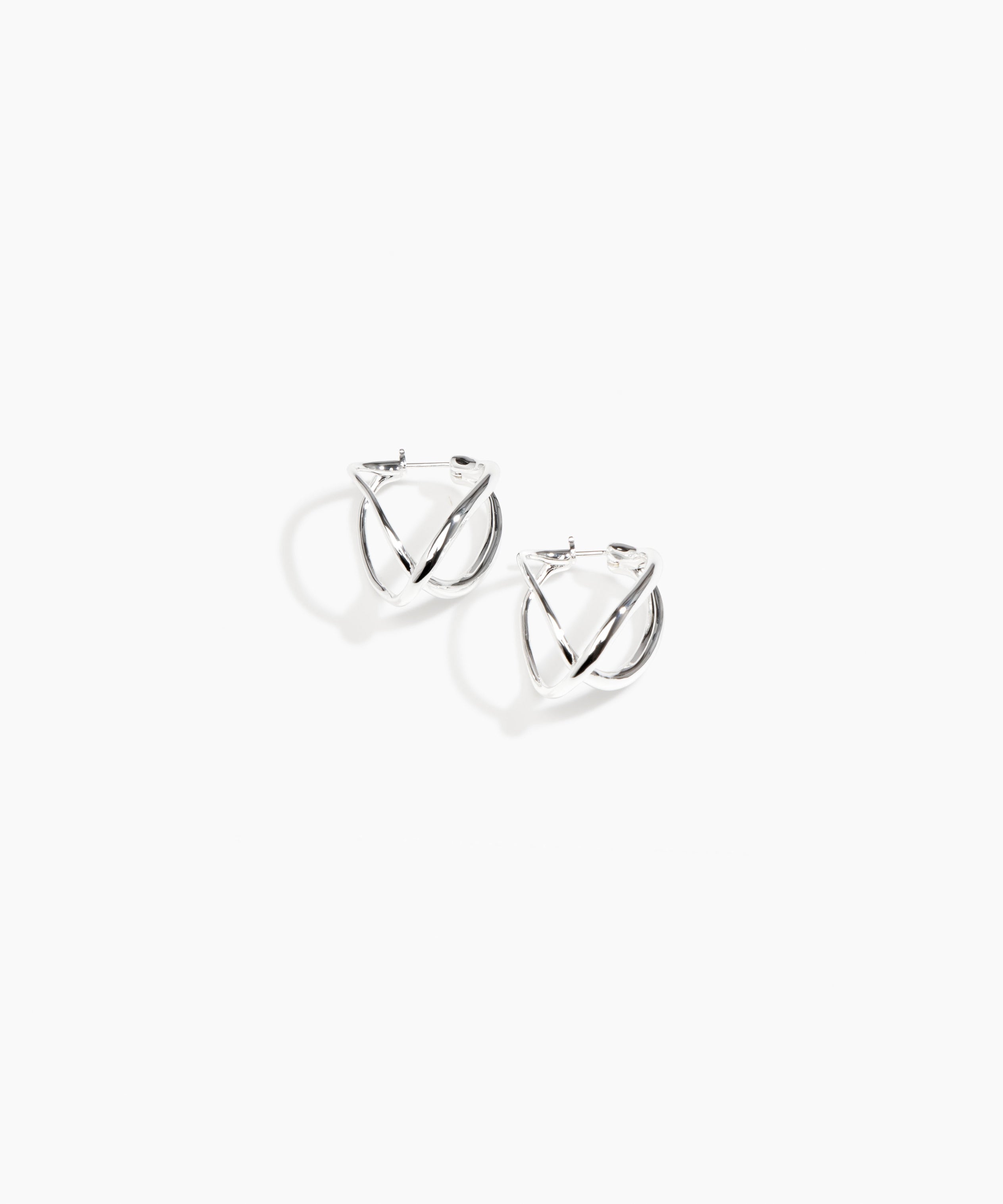 Dinosaur Designs and Alex & Trahanas Medium Corda Earrings in Silver — polished silver-toned plated hoop earrings with interlinked twisted loop design..
