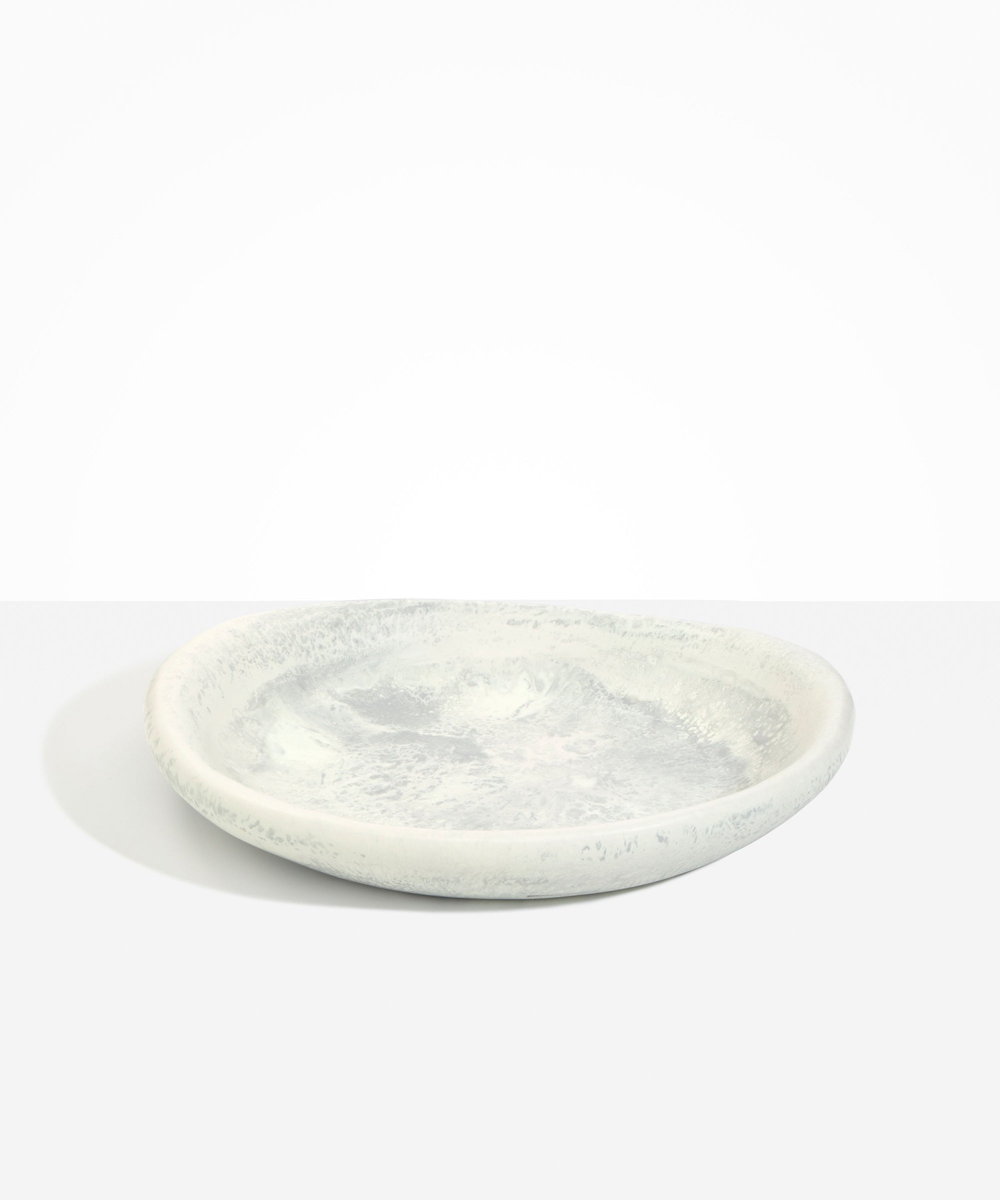 Dinosaur Designs Large Bones Bowl in Cloud — handmade marbled cream and grey resin shallow serving bowl with a rounded organic form...