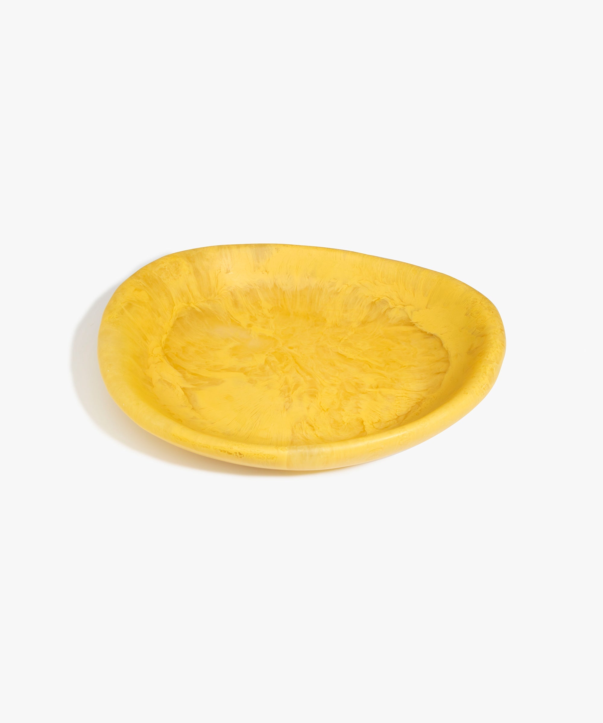 Dinosaur Designs Large Bones Bowl in Pollen — handmade marbled yellow resin shallow serving bowl with a rounded organic form..