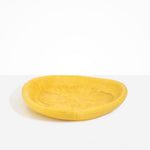 Dinosaur Designs Large Bones Bowl in Pollen — handmade marbled yellow resin shallow serving bowl with a rounded organic form...