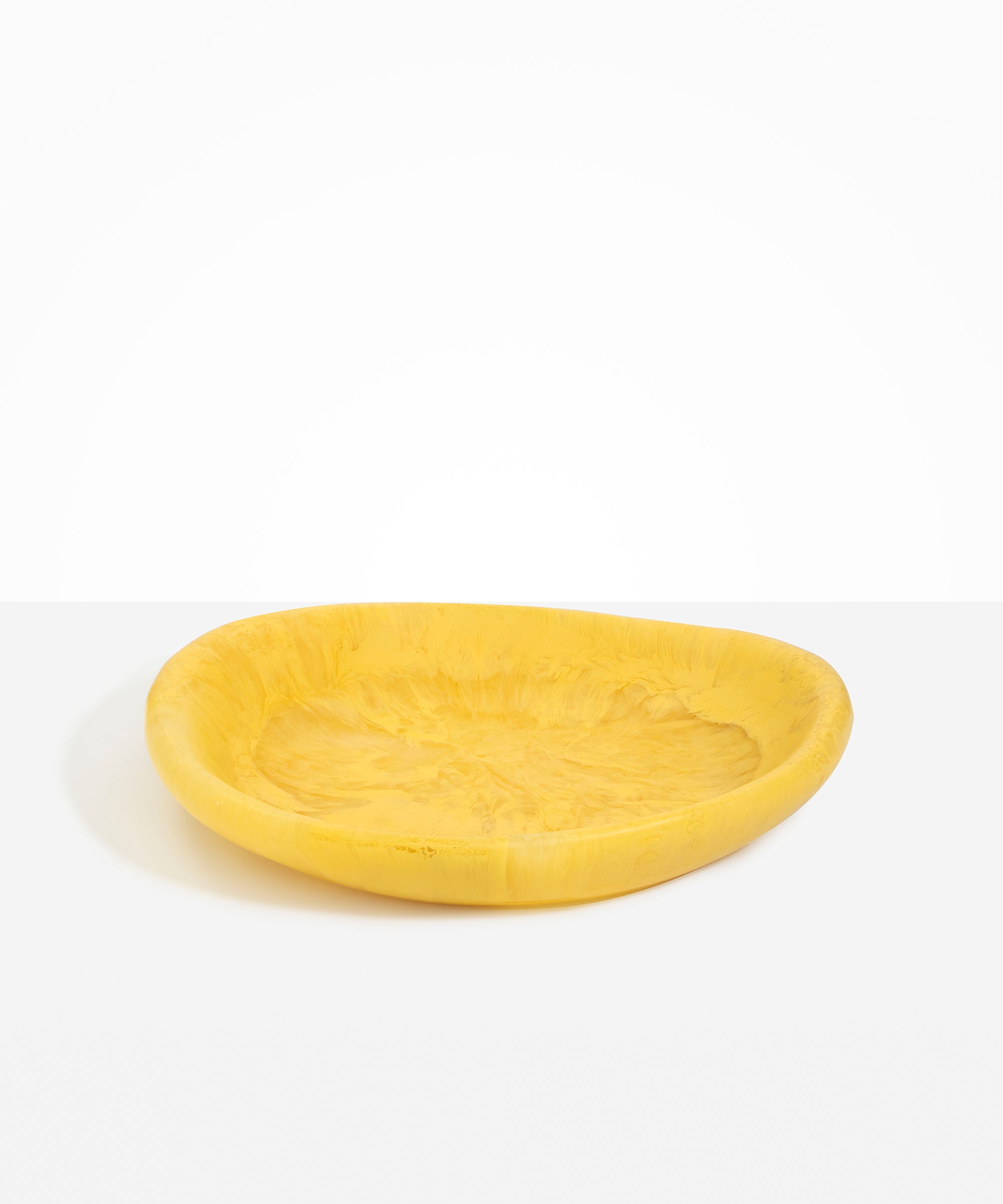 Dinosaur Designs Large Bones Bowl in Pollen — handmade marbled yellow resin shallow serving bowl with a rounded organic form...