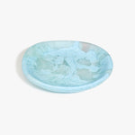 Dinosaur Designs Medium Bones Bowl in Pool — mid sized handmade marbled blue resin shallow serving bowl with a rounded organic form..