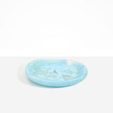 Dinosaur Designs Medium Bones Bowl in Pool — mid sized handmade marbled blue resin shallow serving bowl with a rounded organic form..