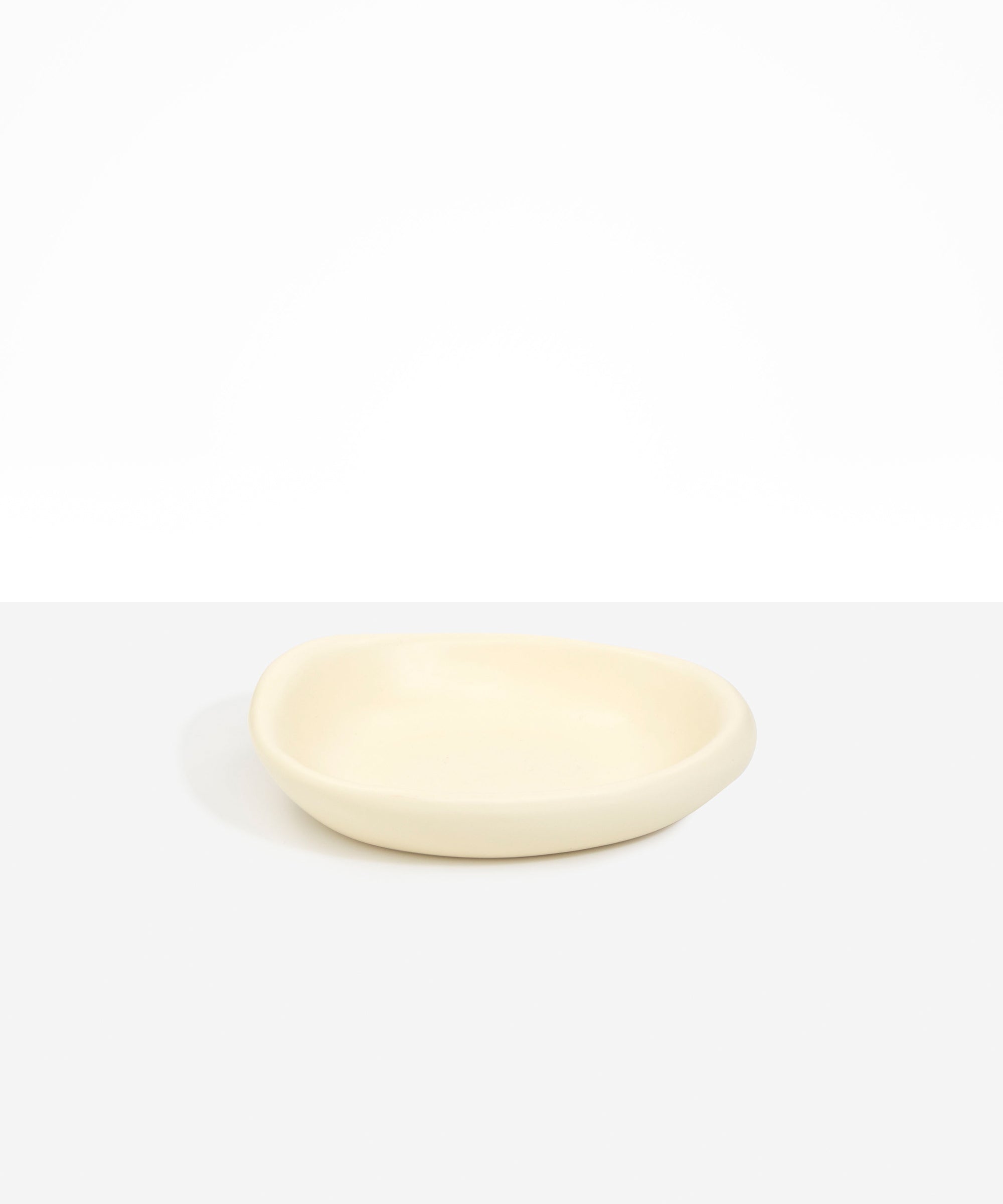 Dinosaur Designs Small Bones Bowl in Cream — small handmade cream resin shallow serving bowl with a rounded organic form