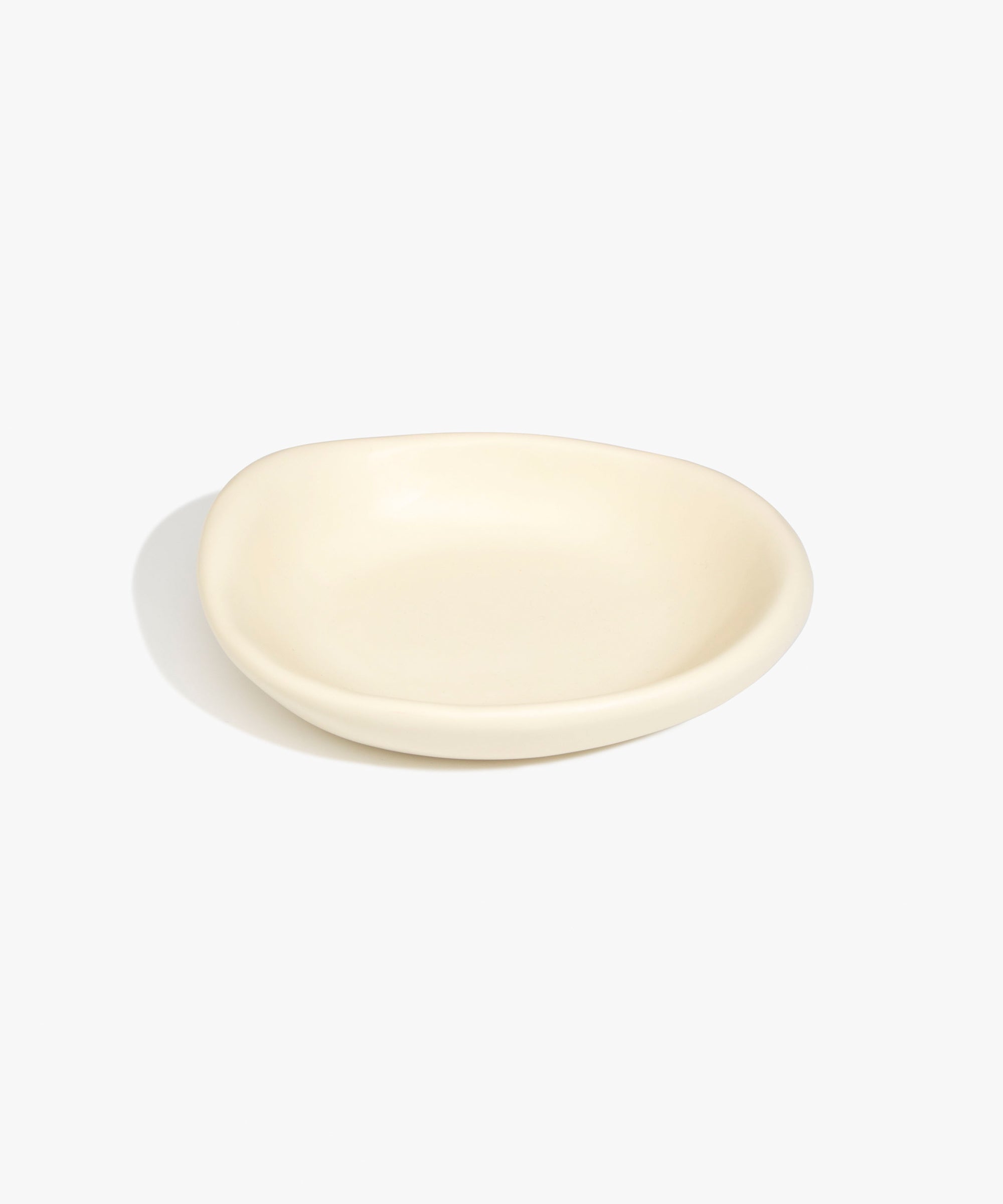 Dinosaur Designs Small Bones Bowl in Cream — small handmade cream resin shallow serving bowl with a rounded organic form