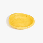 Dinosaur Designs Small Bones Bowl in Pollen — small handmade marbled yellow resin shallow serving bowl with a rounded organic form..