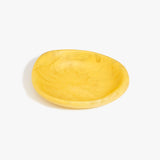 Dinosaur Designs Small Bones Bowl in Pollen — small handmade marbled yellow resin shallow serving bowl with a rounded organic form..