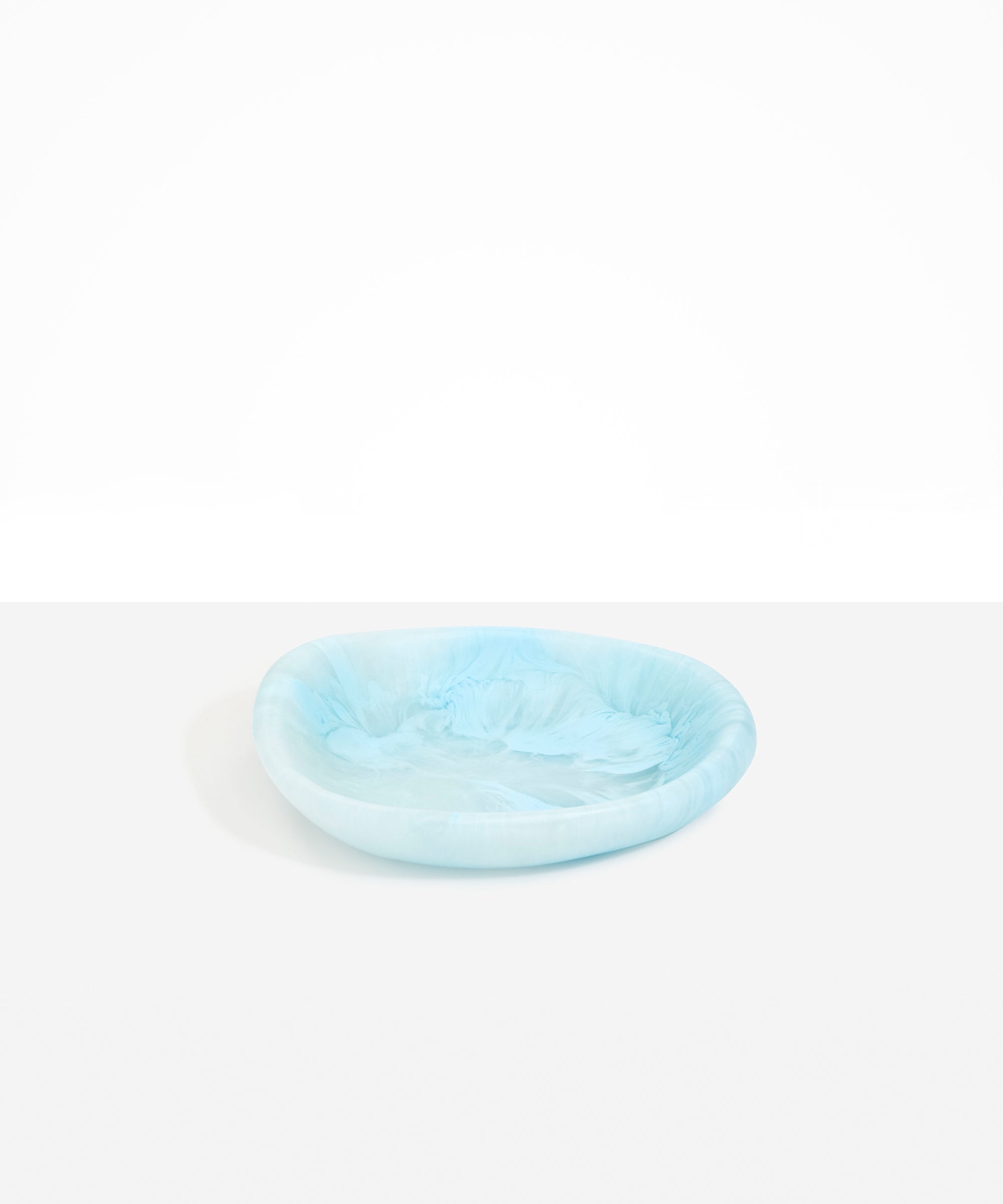 Dinosaur Designs Small Bones Bowl in Pool — small handmade marbled blue resin shallow serving bowl with a rounded organic form..