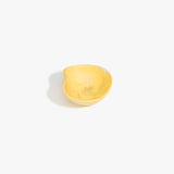 Dinosaur Designs Petal Dessert Bowl in Pollen — handcrafted marbled yellow resin bowl with curved form and pinched organic rim