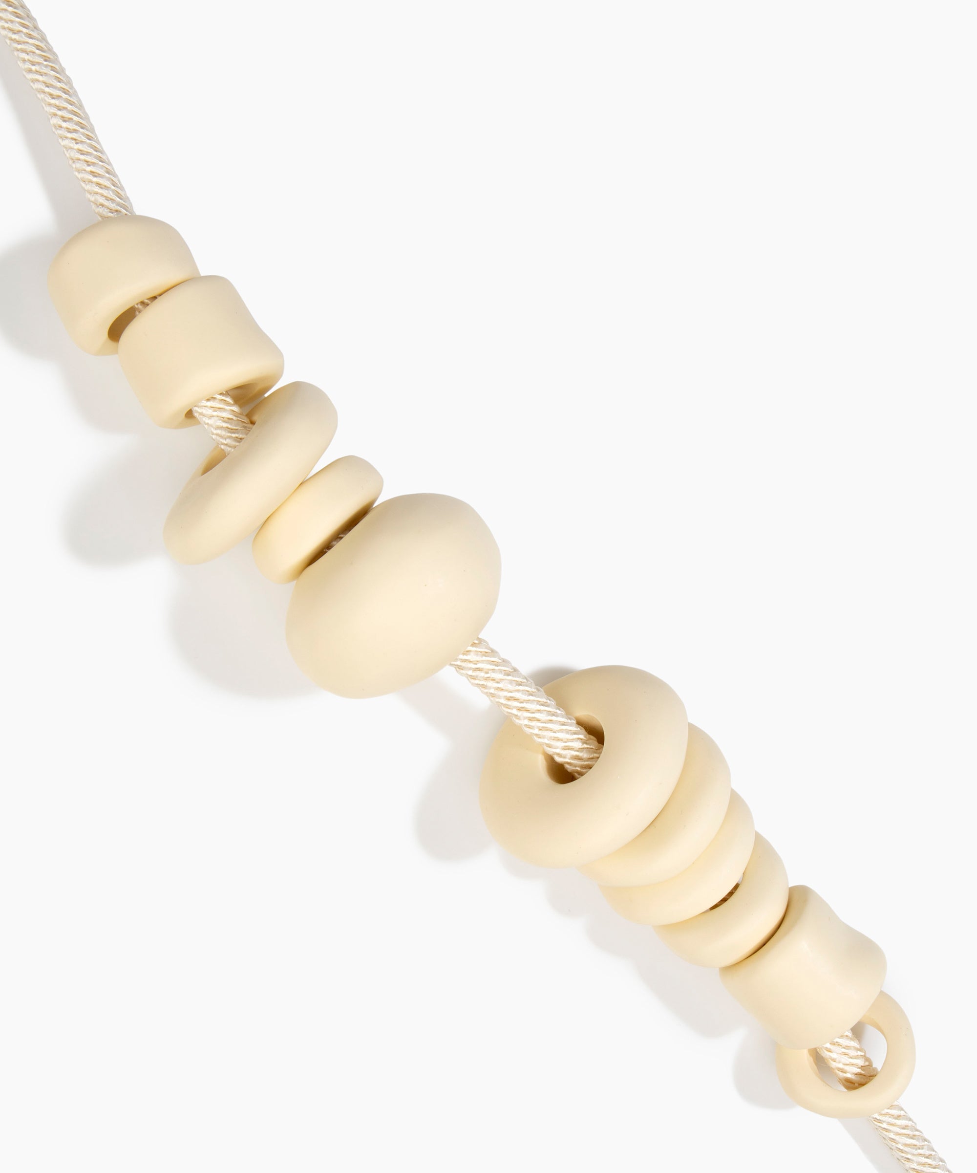 Dinosaur Designs Drift Choker in Cream with Plated-Silver — cream resin pebble beads on a wood silk cord with silver-plated end cap