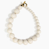 Dinosaur Designs Polished Organic Ball Choker in Chalk Swirl — handcrafted marbled off-white and clear polished resin graduating bead choker necklace with brass t-bar clasp
