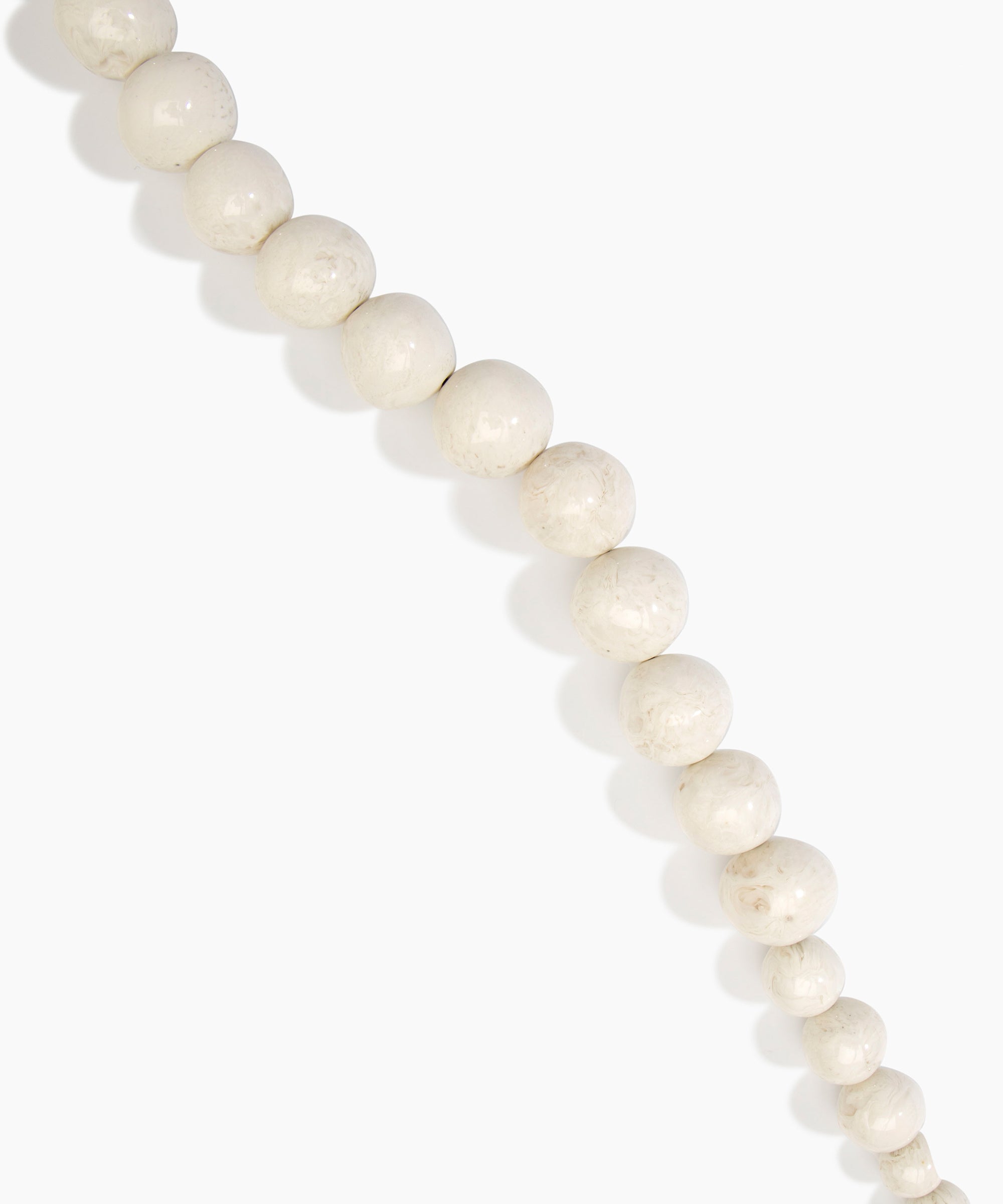 Dinosaur Designs Polished Organic Ball Choker in Chalk Swirl — handcrafted marbled off-white and clear polished resin graduating bead choker necklace with brass t-bar clasp