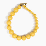 Dinosaur Designs Polished Organic Ball Choker in Pollen — handcrafted marbled yellow and clear polished resin graduating bead choker necklace with brass t-bar clasp