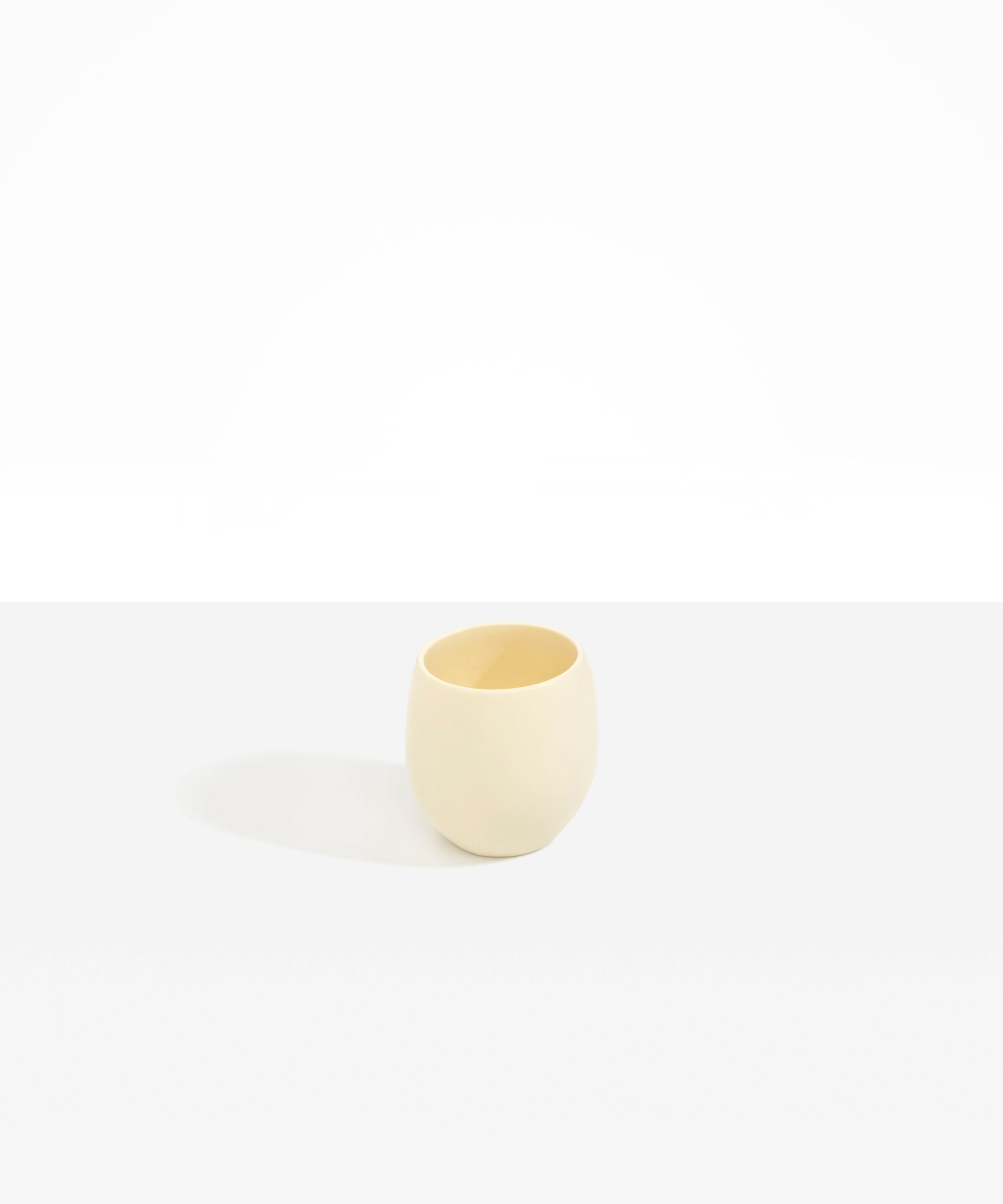 Dinosaur Designs Large Rock Cup in Cream — handcrafted cream resin cup with rounded bulbous form and open organic rim