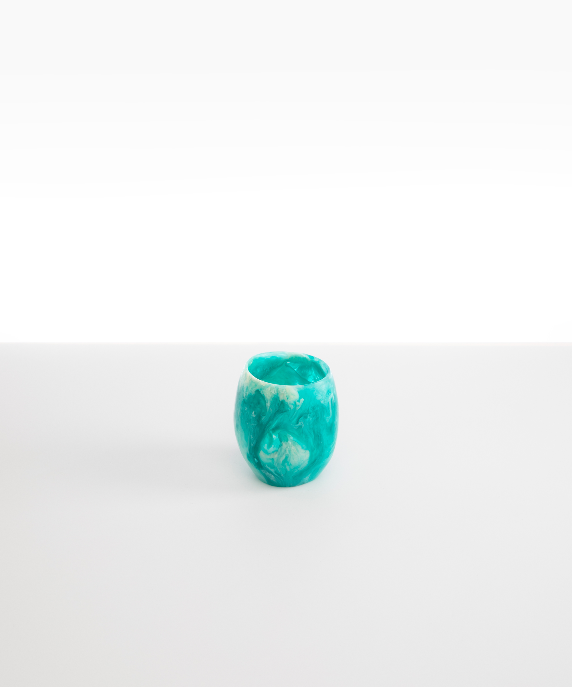 Dinosaur Designs Large Rock Cup in Lagoon — handcrafted marbled blue, cream and clear resin cup with rounded bulbous form and open organic rim
