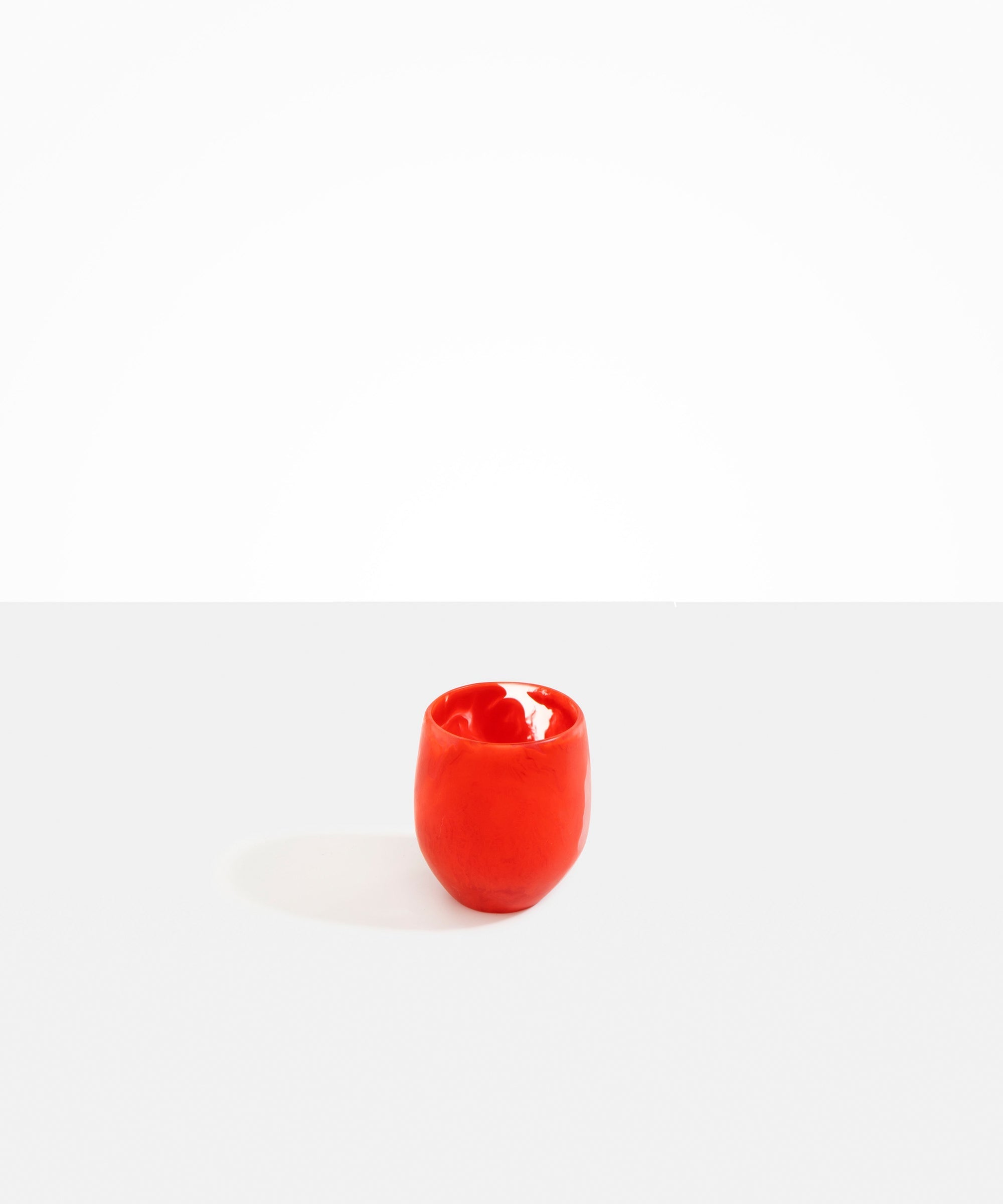 Dinosaur Designs Large Rock Cup in Poppy — handcrafted marbled red and transparent resin cup with rounded bulbous form and open organic rim