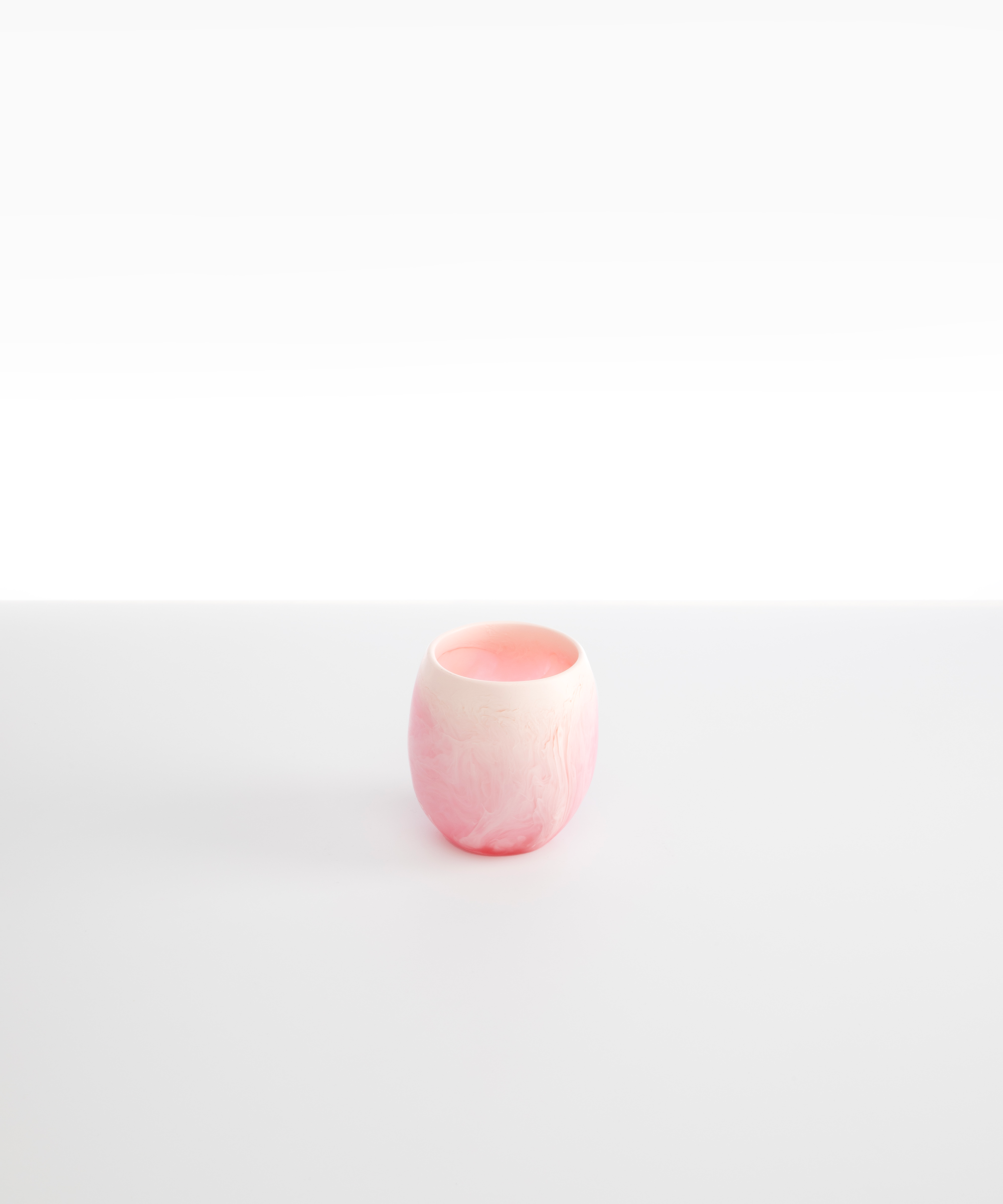 Dinosaur Designs Large Rock Cup in Shell Pink — handcrafted marbled pink and transparent resin cup with rounded bulbous form and open organic rim