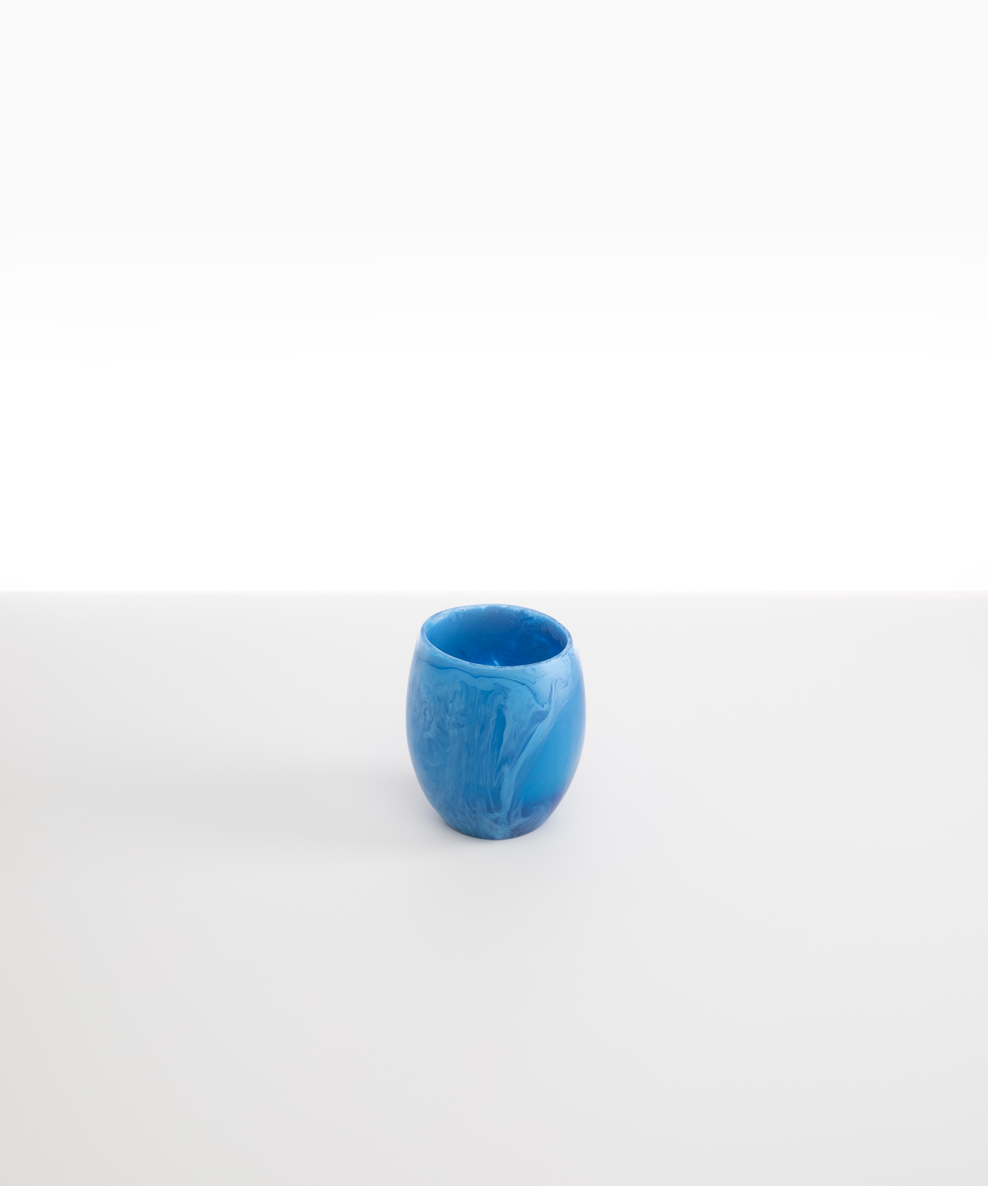 Dinosaur Designs Large Rock Cup in Sky — handcrafted marbled blue and transparent resin cup with rounded bulbous form and open organic rim