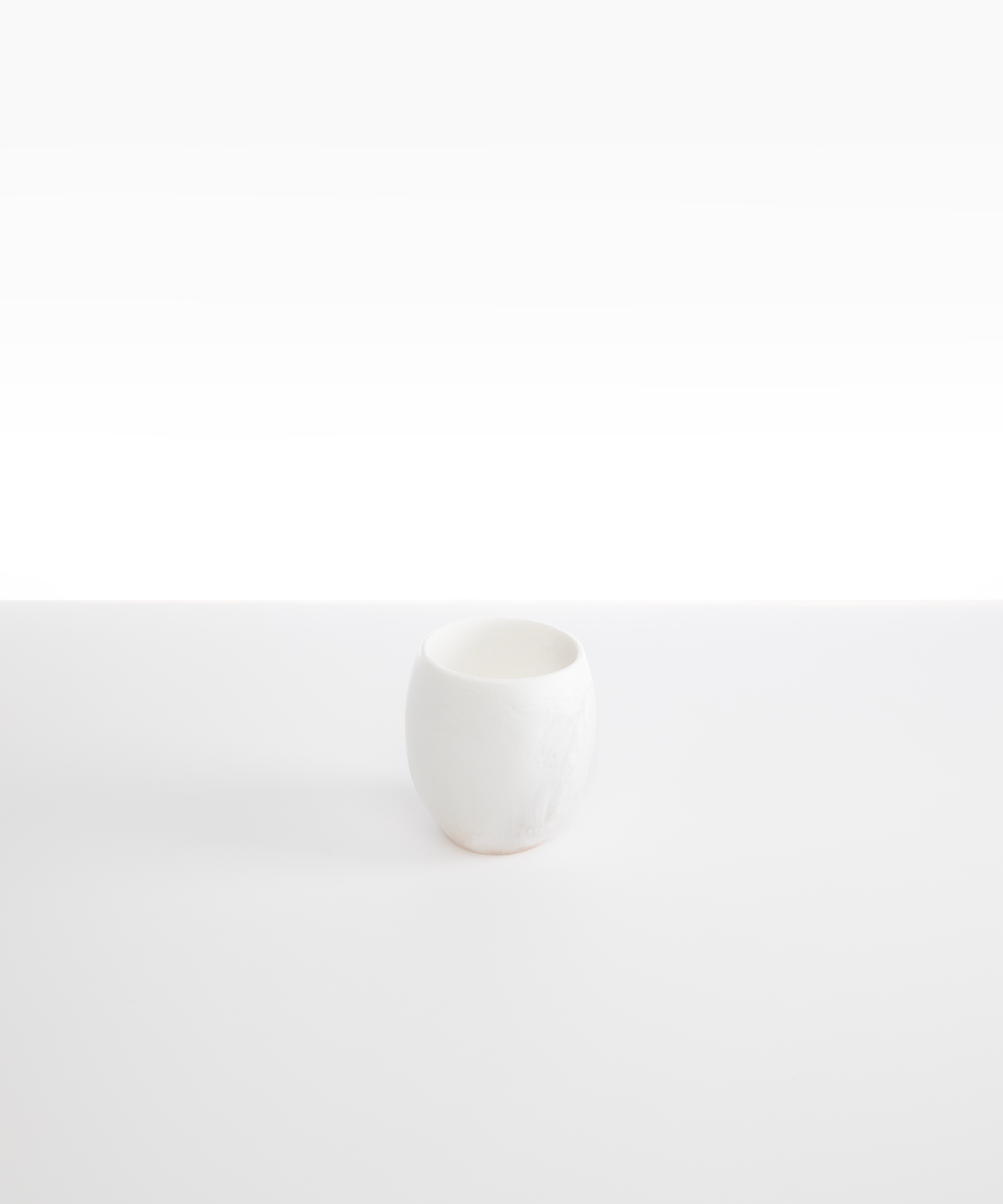 Dinosaur Designs Large Rock Cup in Snow Swirl — handcrafted marbled white and transparent resin cup with rounded bulbous form and open organic rim
