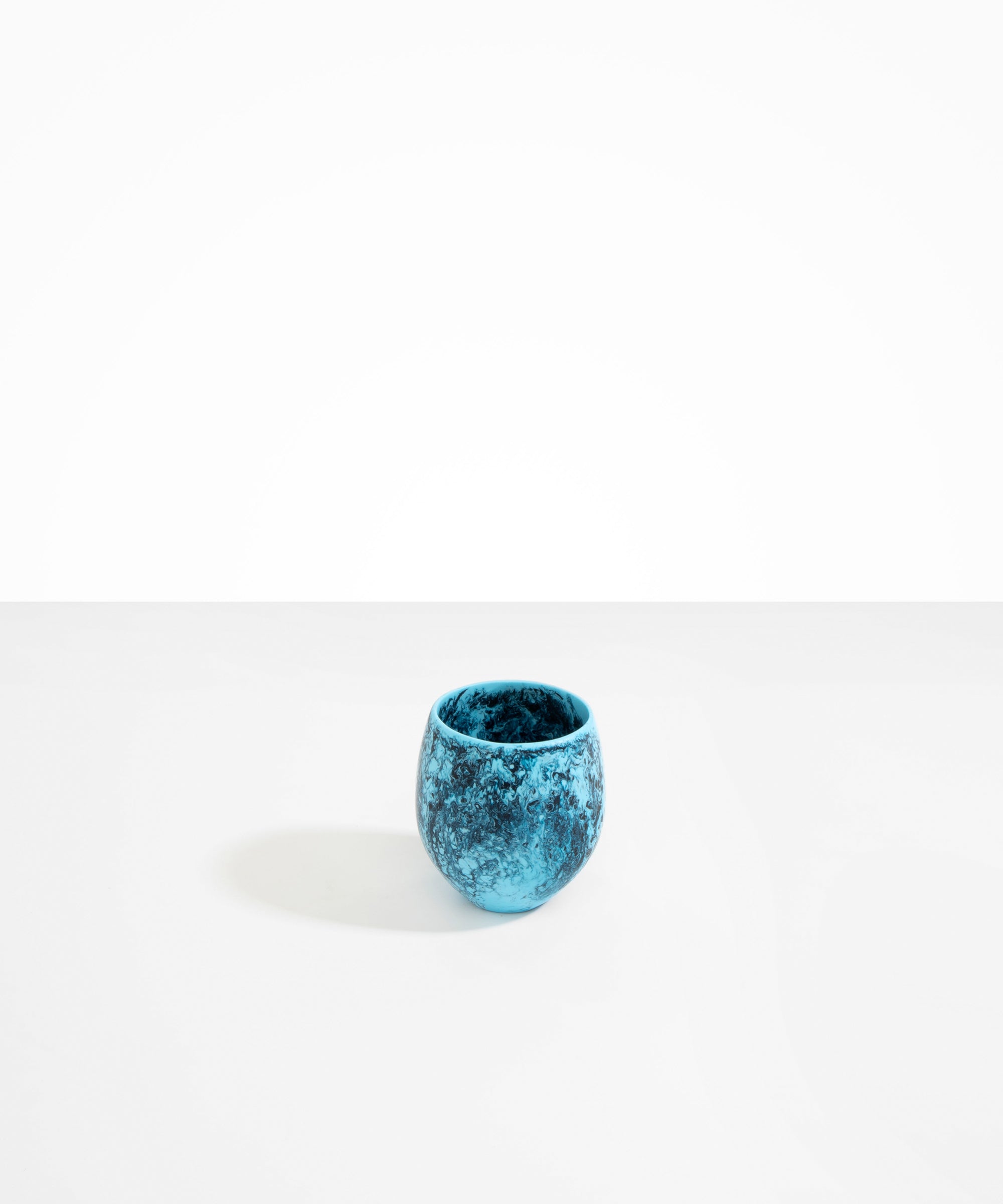 Dinosaur Designs Large Rock Cup in Water — handcrafted marbled blue resin cup with rounded bulbous form and open organic rim