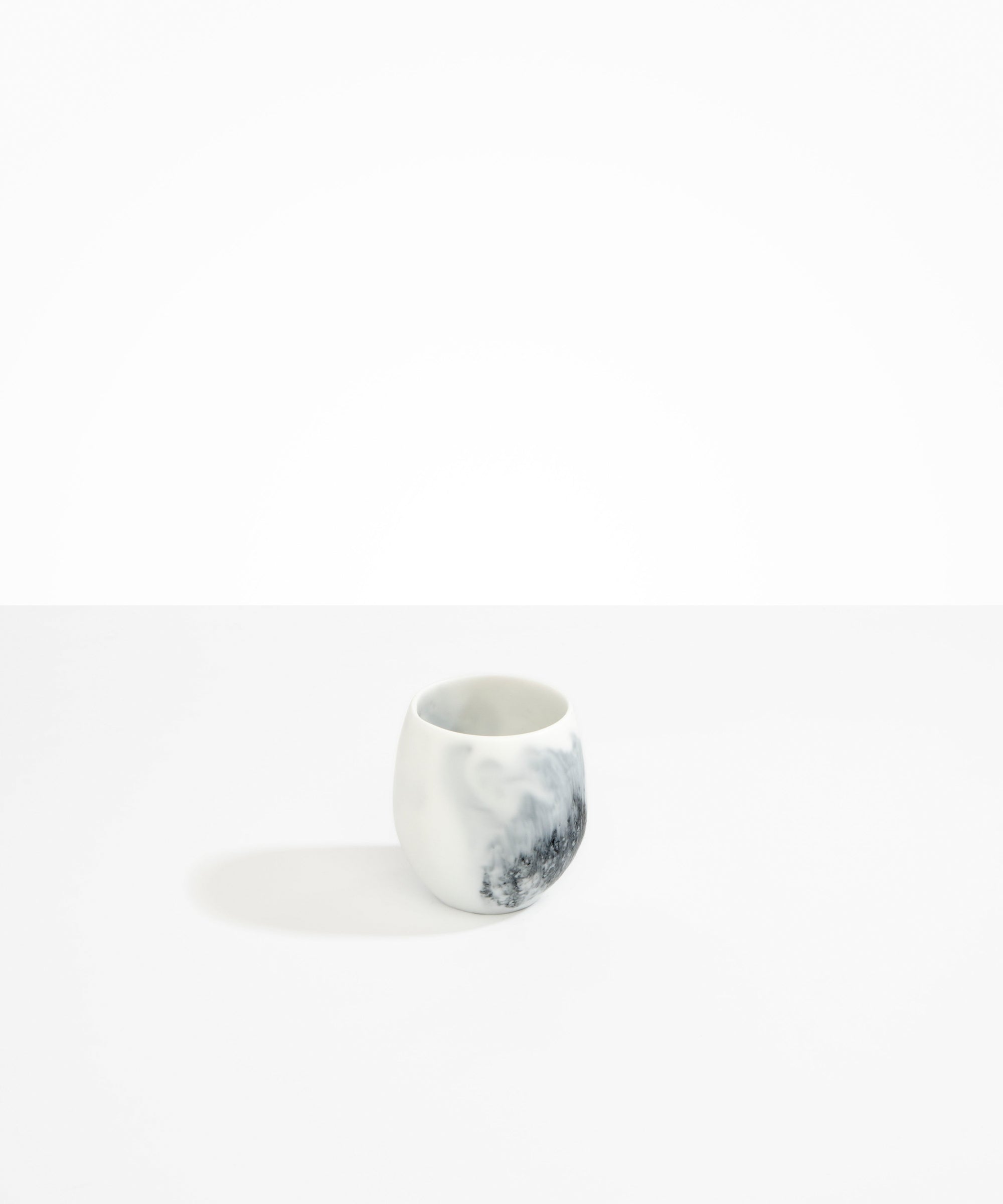 Dinosaur Designs Large Rock Cup in White Marble — handcrafted marbled white and black resin cup with rounded bulbous form and open organic rim