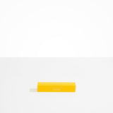 Dinosaur Designs Corey Ashford Citrus Grove Japanese Incense — yellow box of sandalwood, yuzu and orange scented incense sticks..