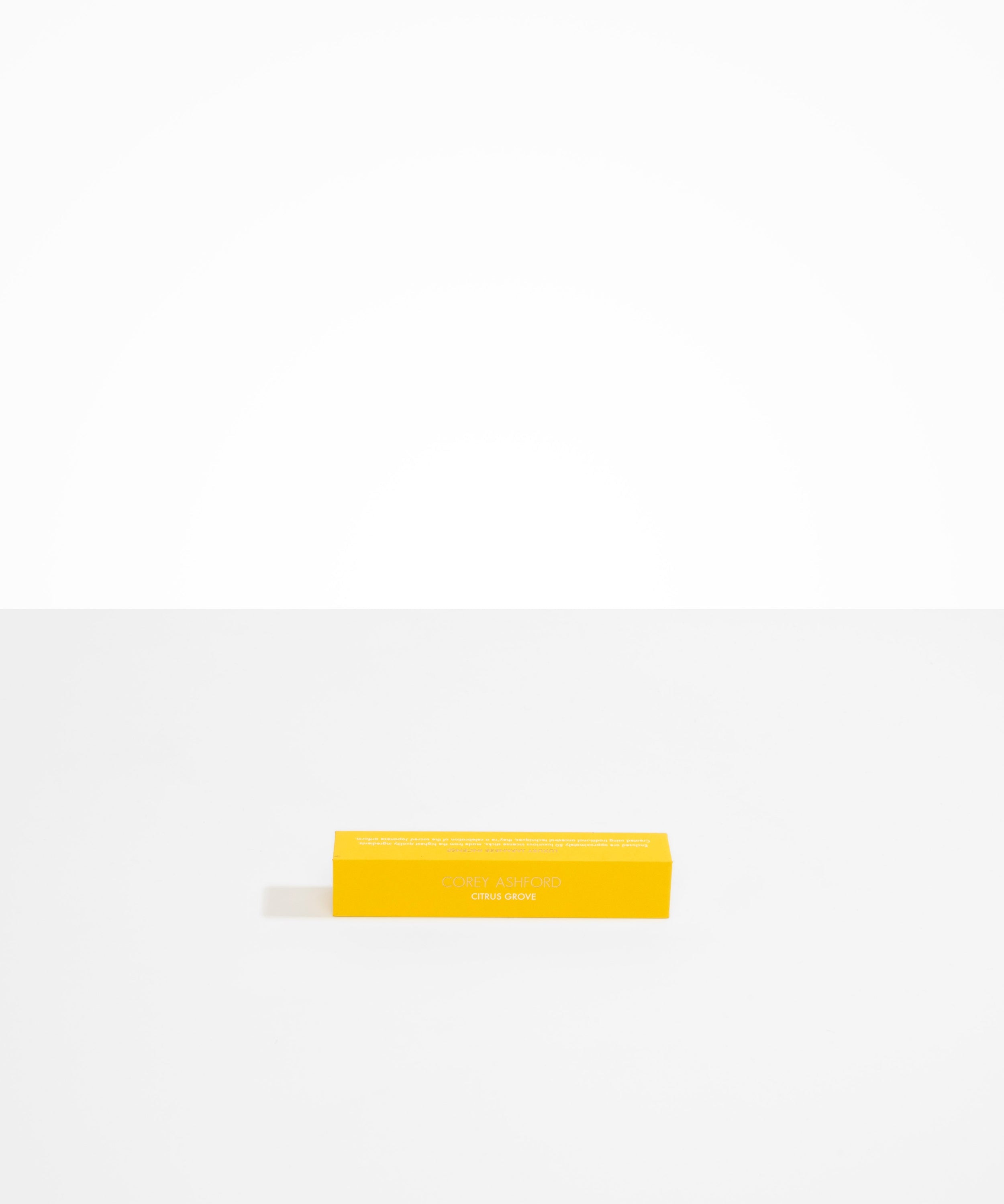 Dinosaur Designs Corey Ashford Citrus Grove Japanese Incense — yellow box of sandalwood, yuzu and orange scented incense sticks..