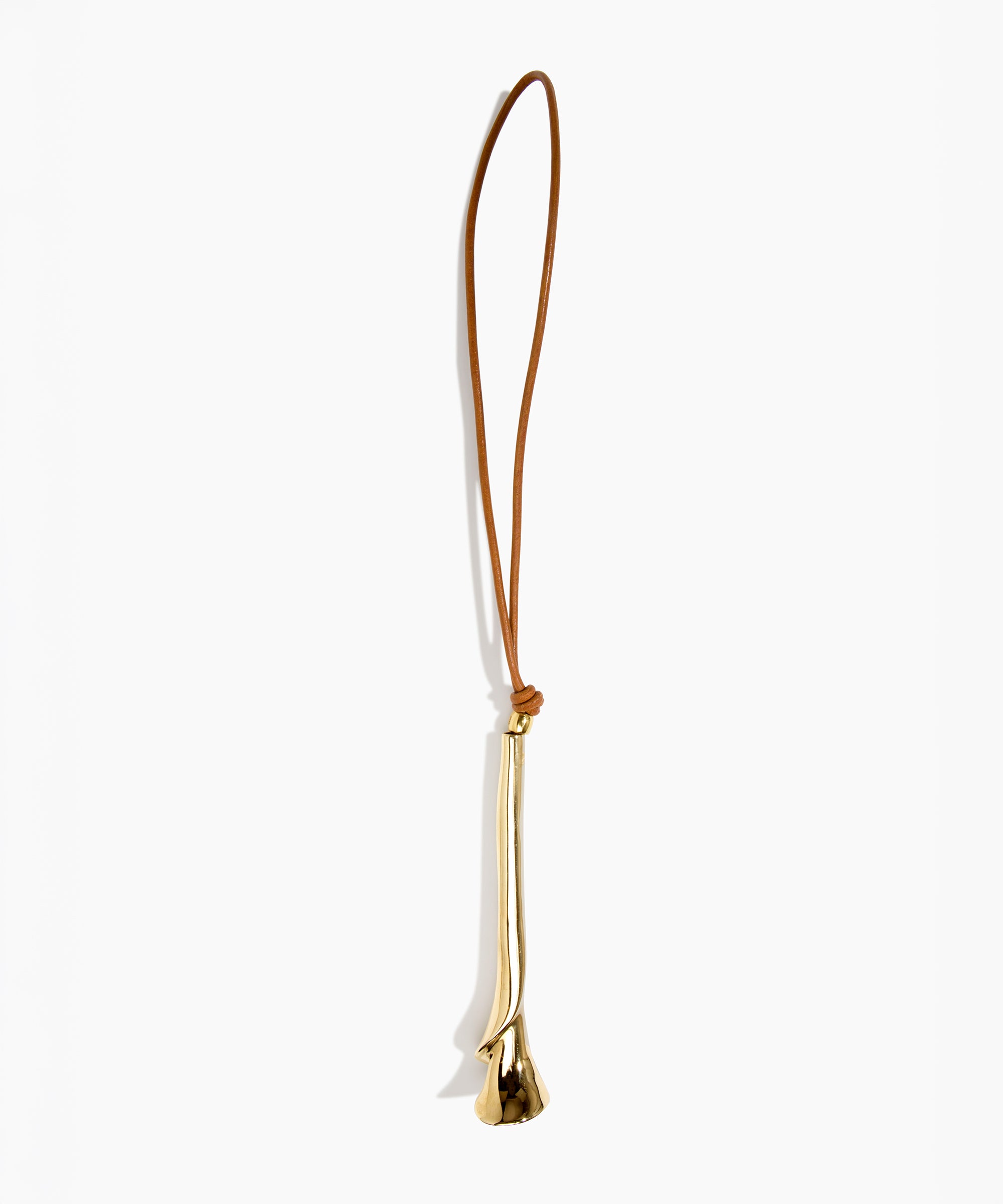 Dinosaur Designs Metal Flower Decoration in Brass — polished brass cast lily-shaped decoration with tan leather hanging loop