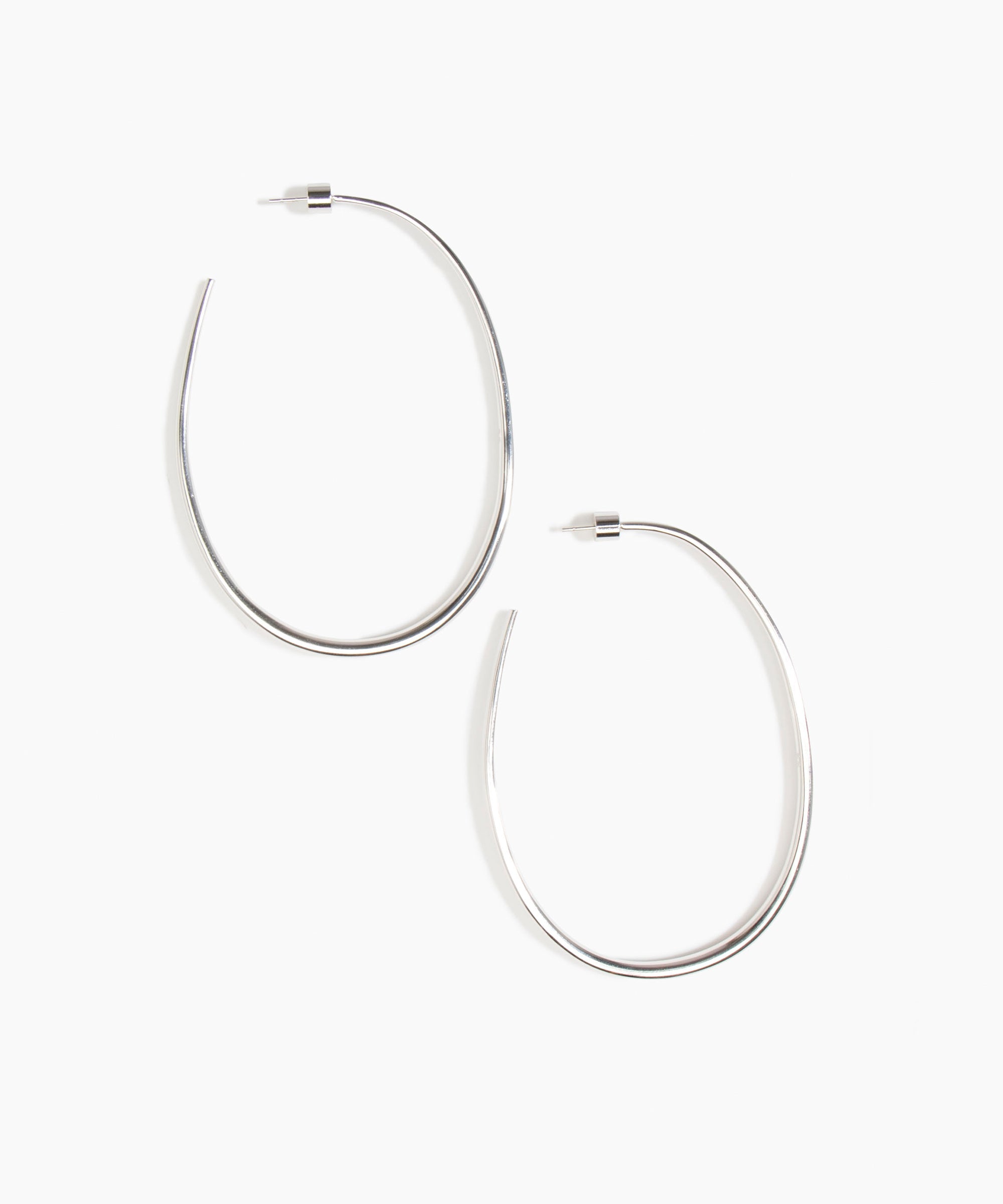Dinosaur Designs Large Pebble Hoop Earrings in Silver-Plated Brass — polished silver-plated brass oversized oval hoop earrings with tapered wire and stud fastening
