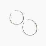 Dinosaur Designs Large Pebble Hoop Earrings in Silver-Plated Brass — polished silver-plated brass oversized oval hoop earrings with tapered wire and stud fastening