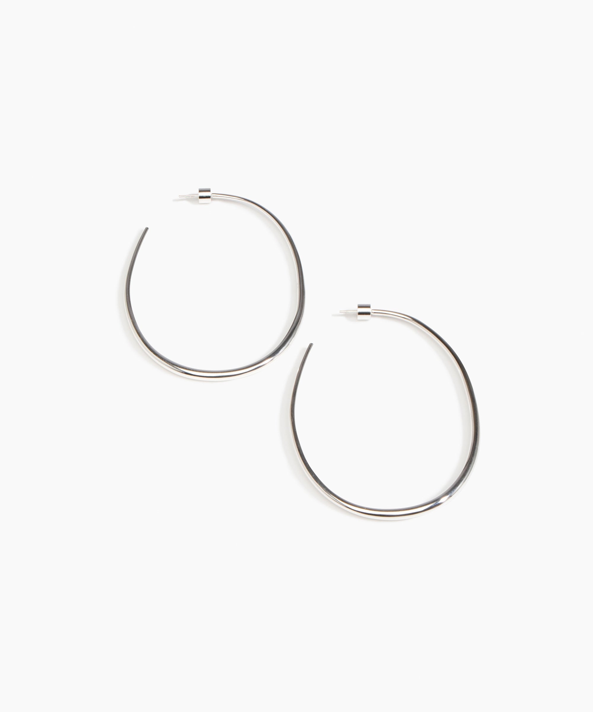 Dinosaur Designs Large Pebble Hoop Earrings in Silver-Plated Brass — polished silver-plated brass oversized oval hoop earrings with tapered wire and stud fastening