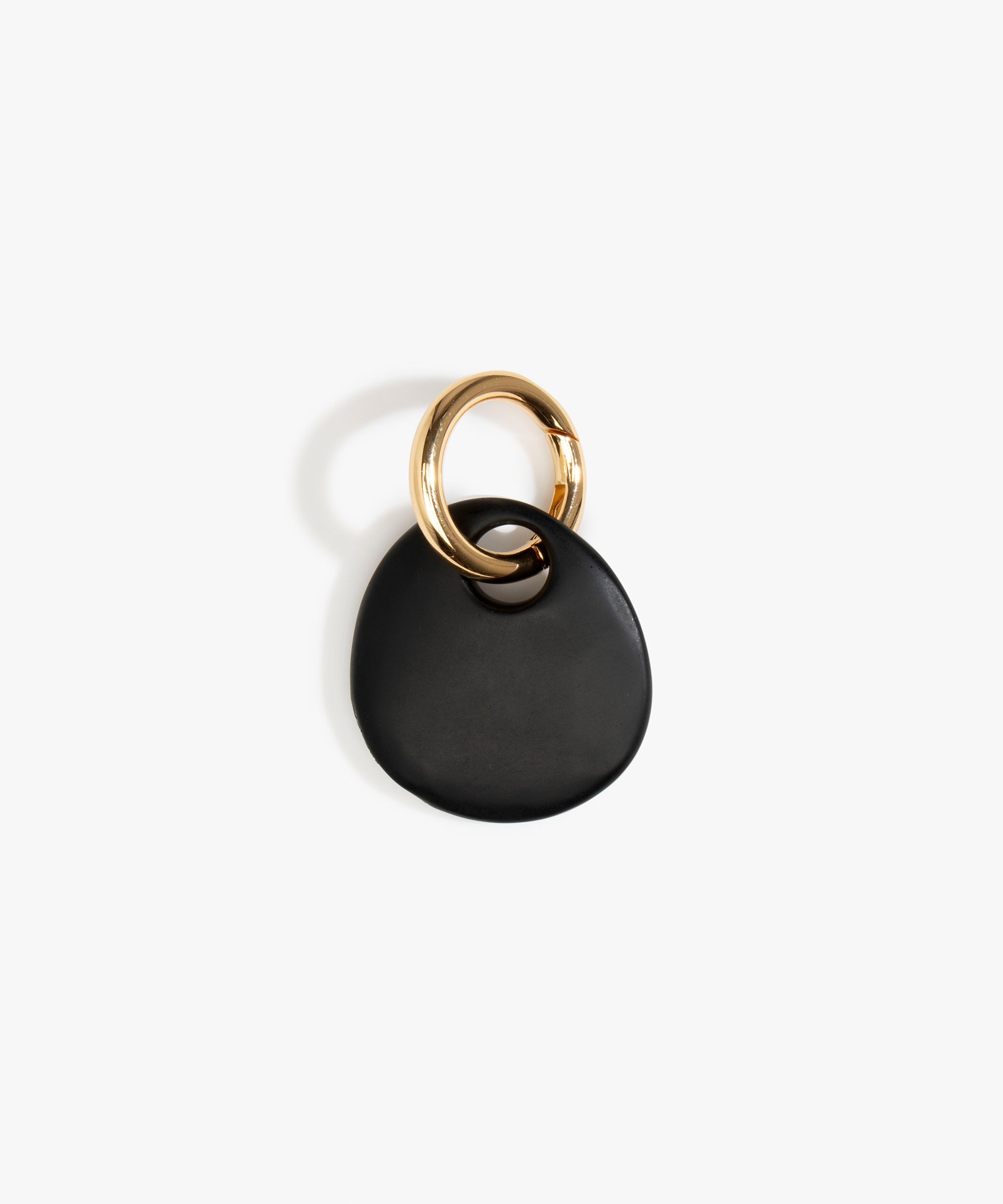 Dinosaur Designs Earth Keyring in Black — handcrafted Black resin pebble bead on a polished brass jump ring..