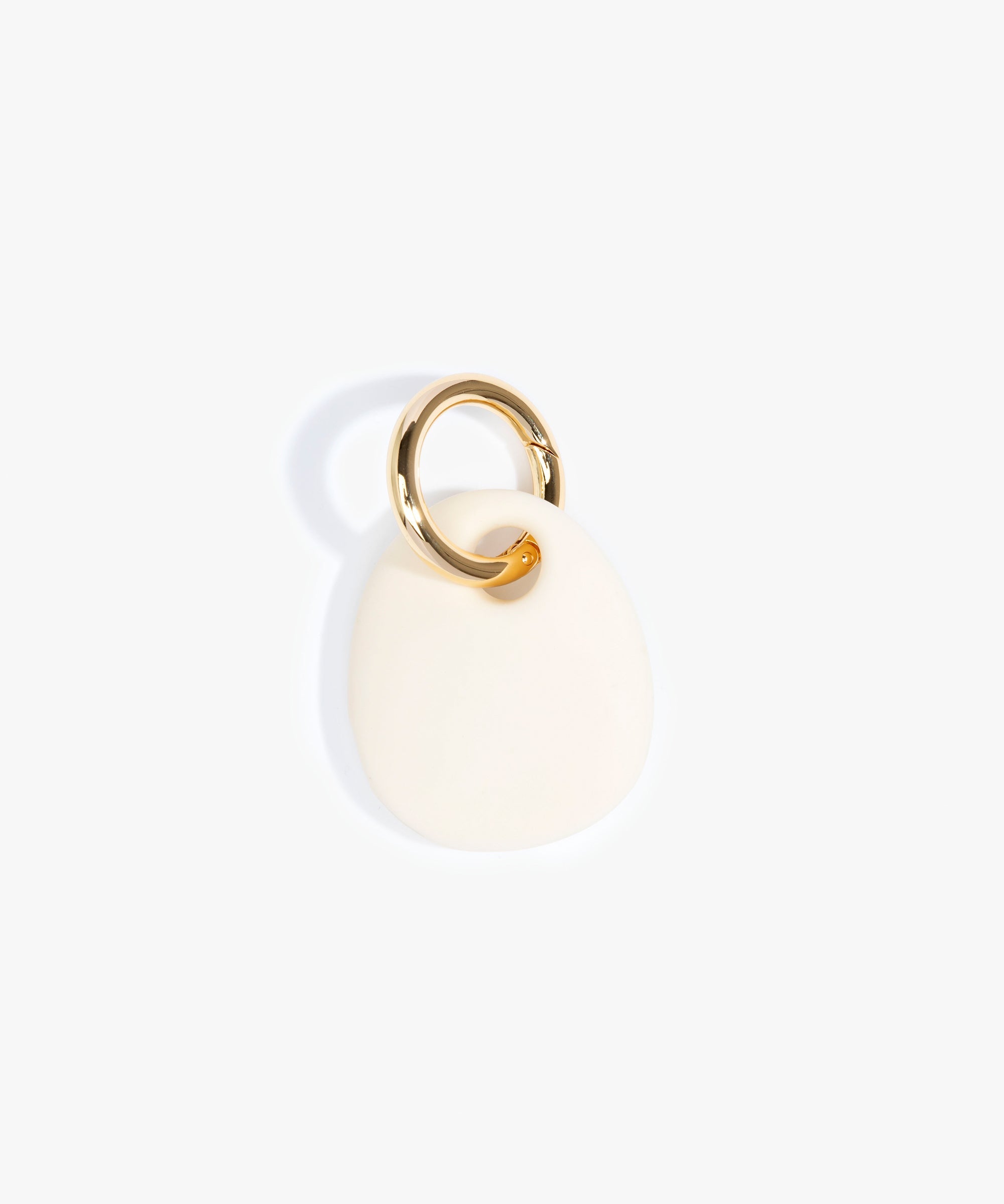Dinosaur Designs Earth Keyring in Cream — handcrafted Cream resin pebble bead on a polished brass jump ring..