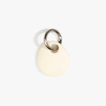 Dinosaur Designs Earth Keyring in Cream — handcrafted Cream resin pebble bead on a polished gunmetal jump ring..