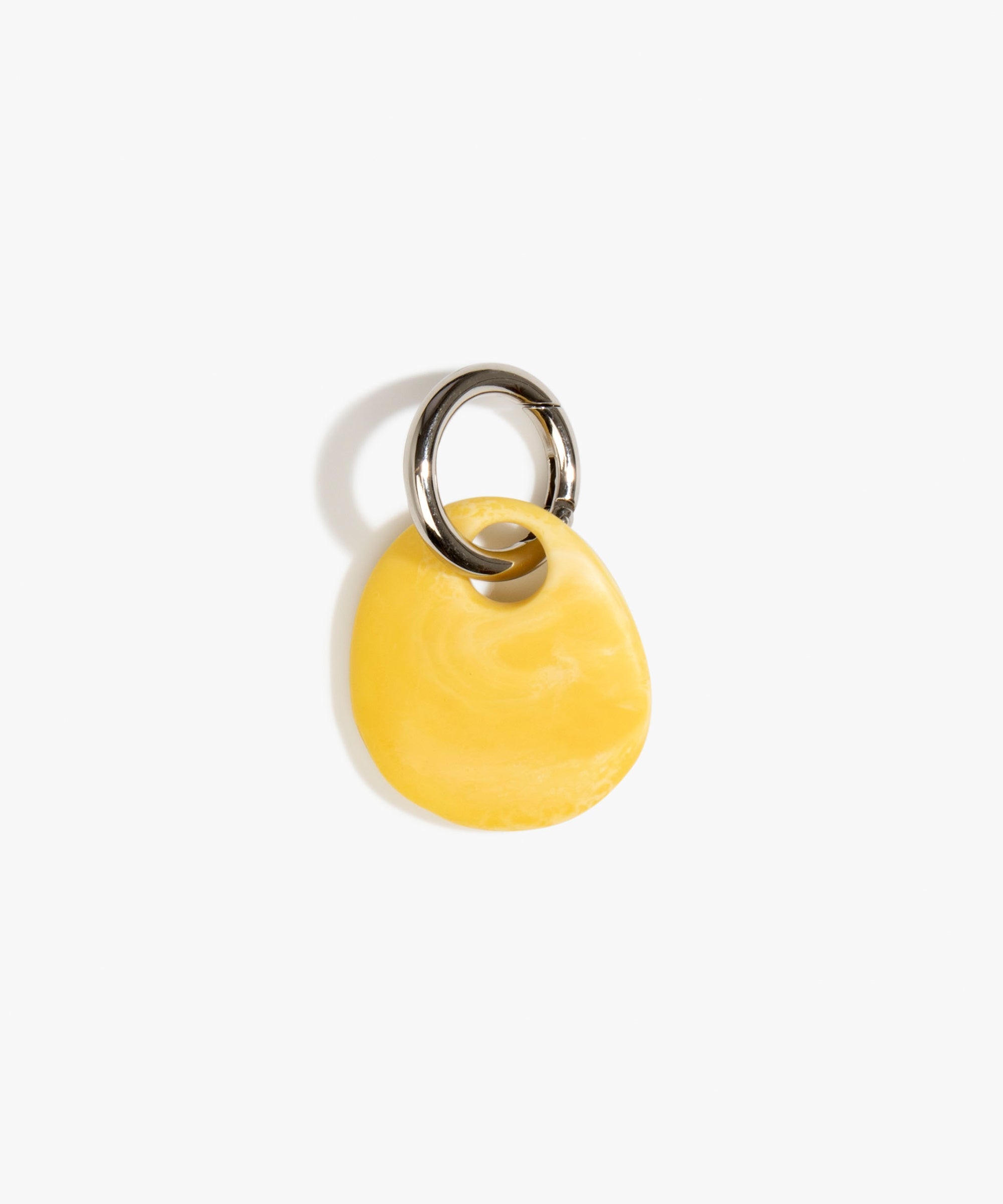 Dinosaur Designs Earth Keyring in Daisy — handcrafted marbled light and dark yellow resin pebble bead on a polished gunmetal jump ring..