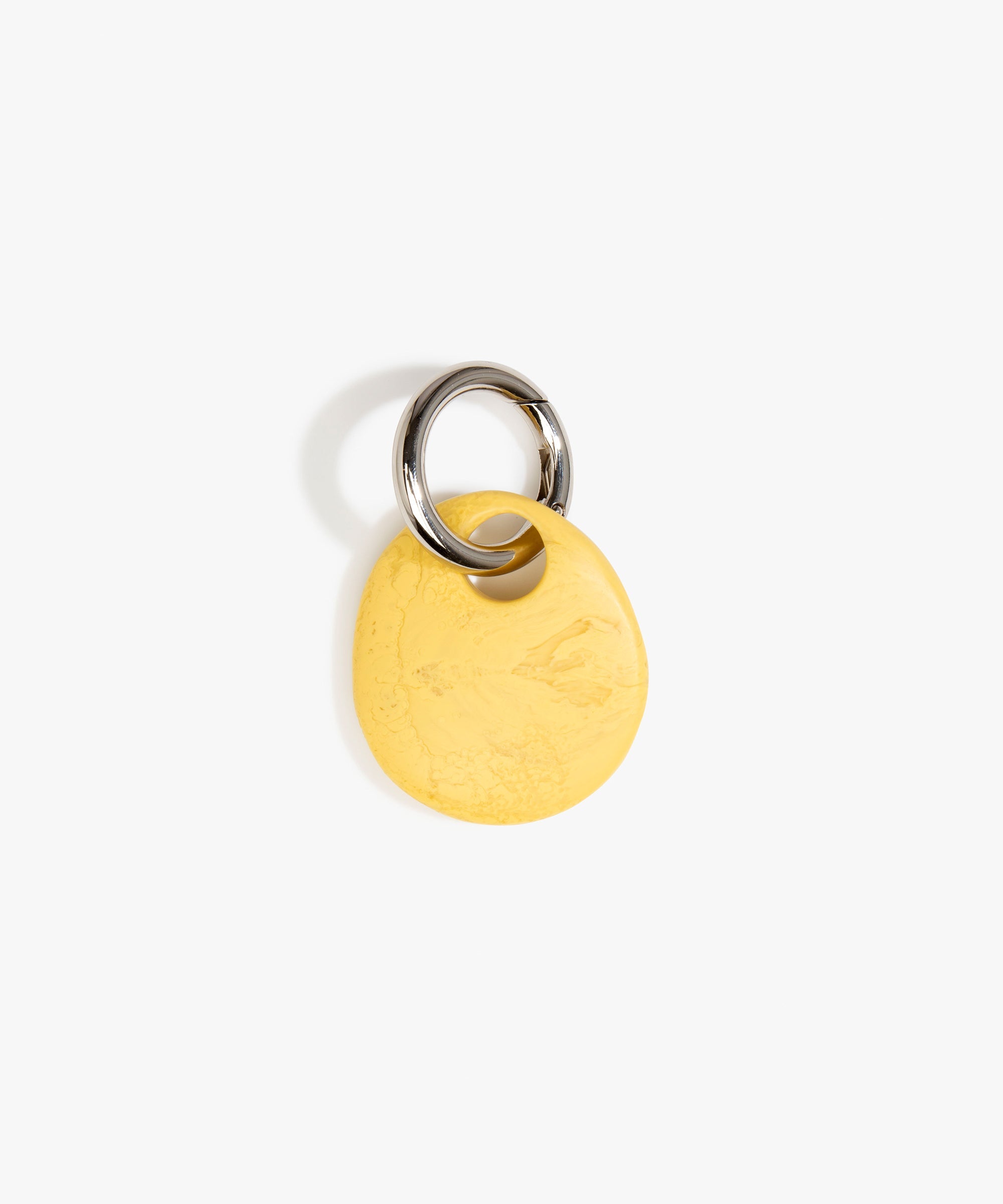 Dinosaur Designs Earth Keyring in Pollen — handcrafted marbled yellow and clear resin pebble bead on a polished gunmetal jump ring..
