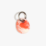 Dinosaur Designs Earth Keyring in Strawberry — handcrafted marbled light and dark red resin pebble bead on a polished gunmetal jump ring..