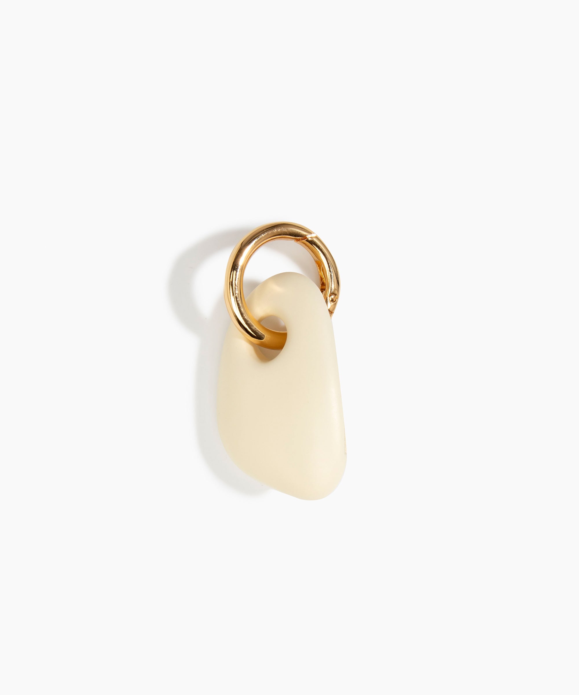 Dinosaur Designs Rock Keyring in Cream — handcrafted cream resin pebble bead on a polished brass jump ring