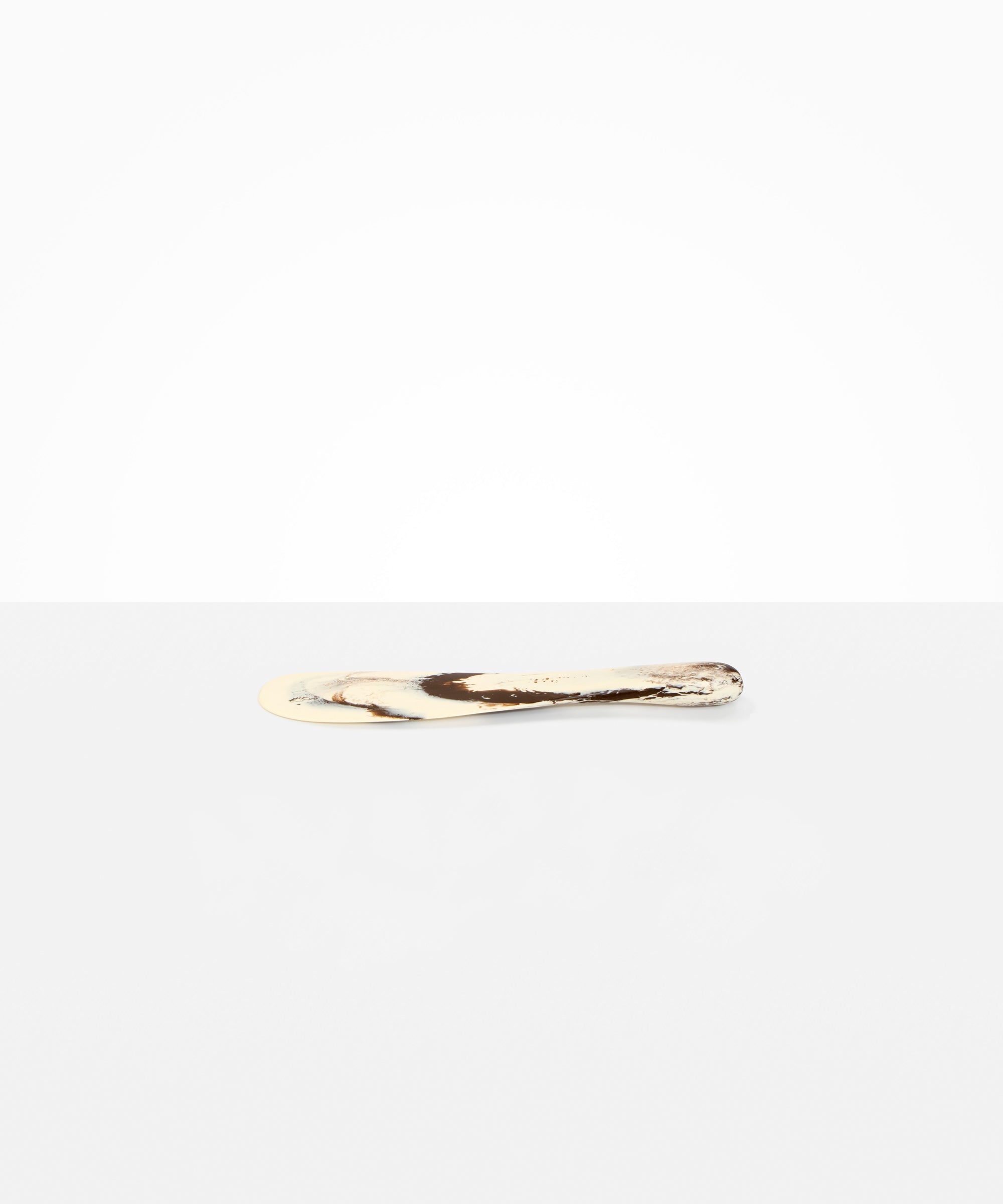 Dinosaur Designs Temple Cake Knife in Cappuccino — handcrafted marbled brown and cream resin cake knife with smooth tapered blade and rounded handle.