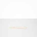 Dinosaur Designs Temple Cake Knife in Chalk Swirl — handcrafted marbled off white resin cake knife with smooth tapered blade and rounded handle.