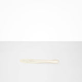 Dinosaur Designs Temple Cake Knife in Chalk Swirl — handcrafted marbled off white resin cake knife with smooth tapered blade and rounded handle.