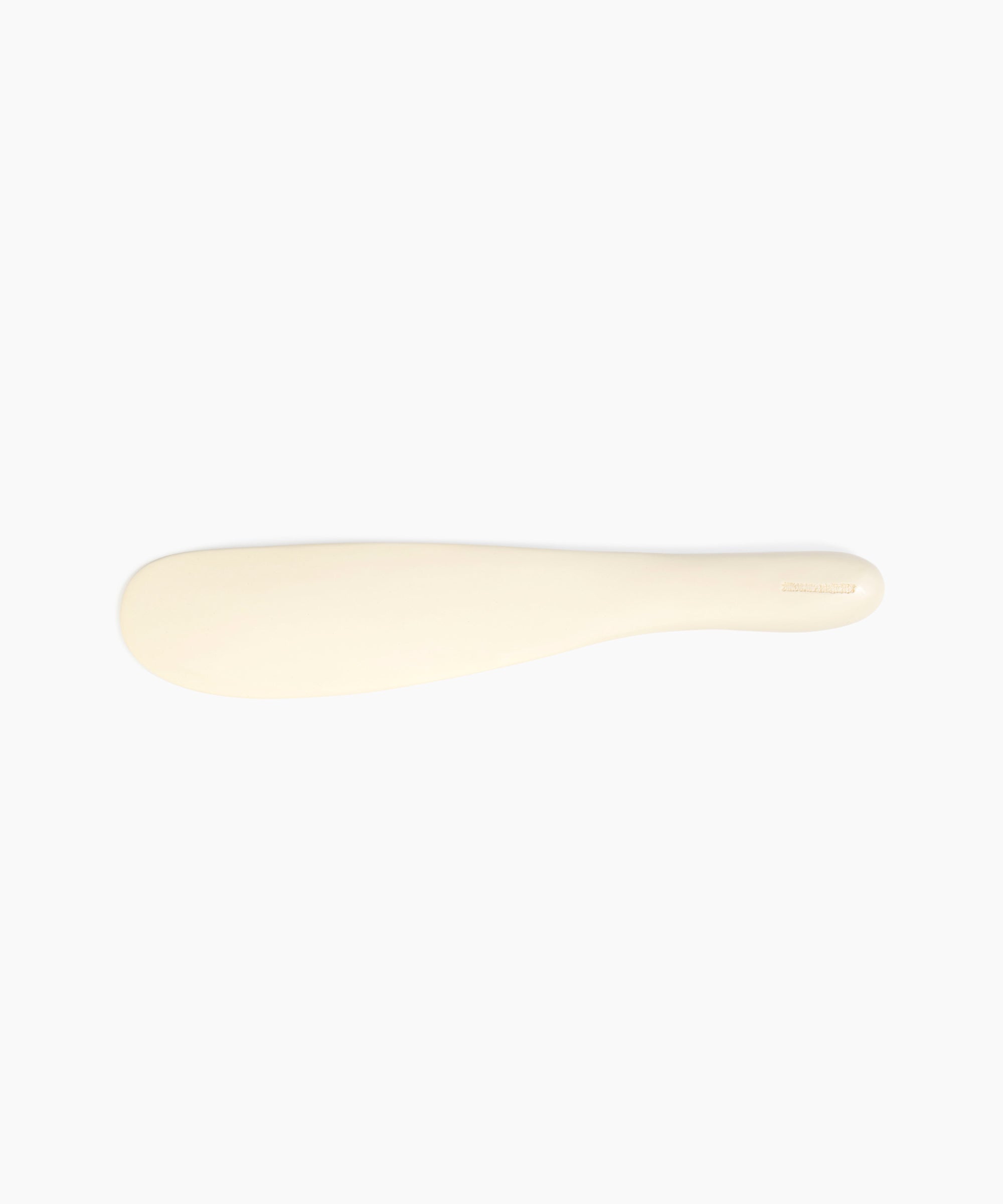 Dinosaur Designs Temple Cake Knife in Cream — handcrafted cream resin cake knife with smooth tapered blade and rounded handle.