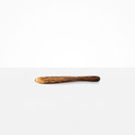 Dinosaur Designs Temple Cake Knife in Dark Horn — handcrafted marbled brown, black and gold resin cake knife with smooth tapered blade and rounded handle.
