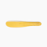 Dinosaur Designs Temple Cake Knife in Pollen — handcrafted marbled yellow and clear resin cake knife with smooth tapered blade and rounded handle.