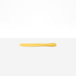 Dinosaur Designs Temple Cake Knife in Pollen — handcrafted marbled yellow and clear resin cake knife with smooth tapered blade and rounded handle.